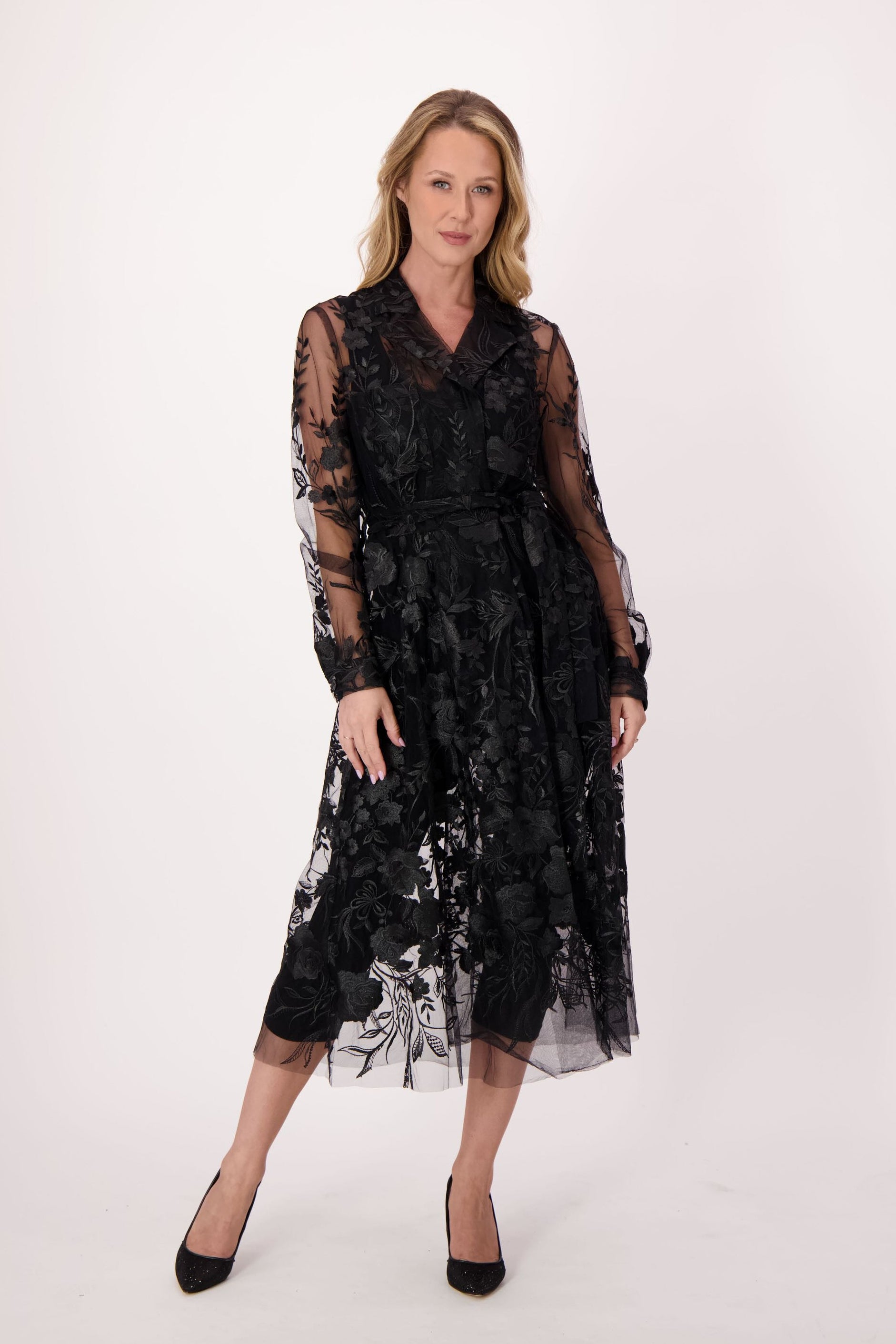 Woman wearing a black lace dress on a white background