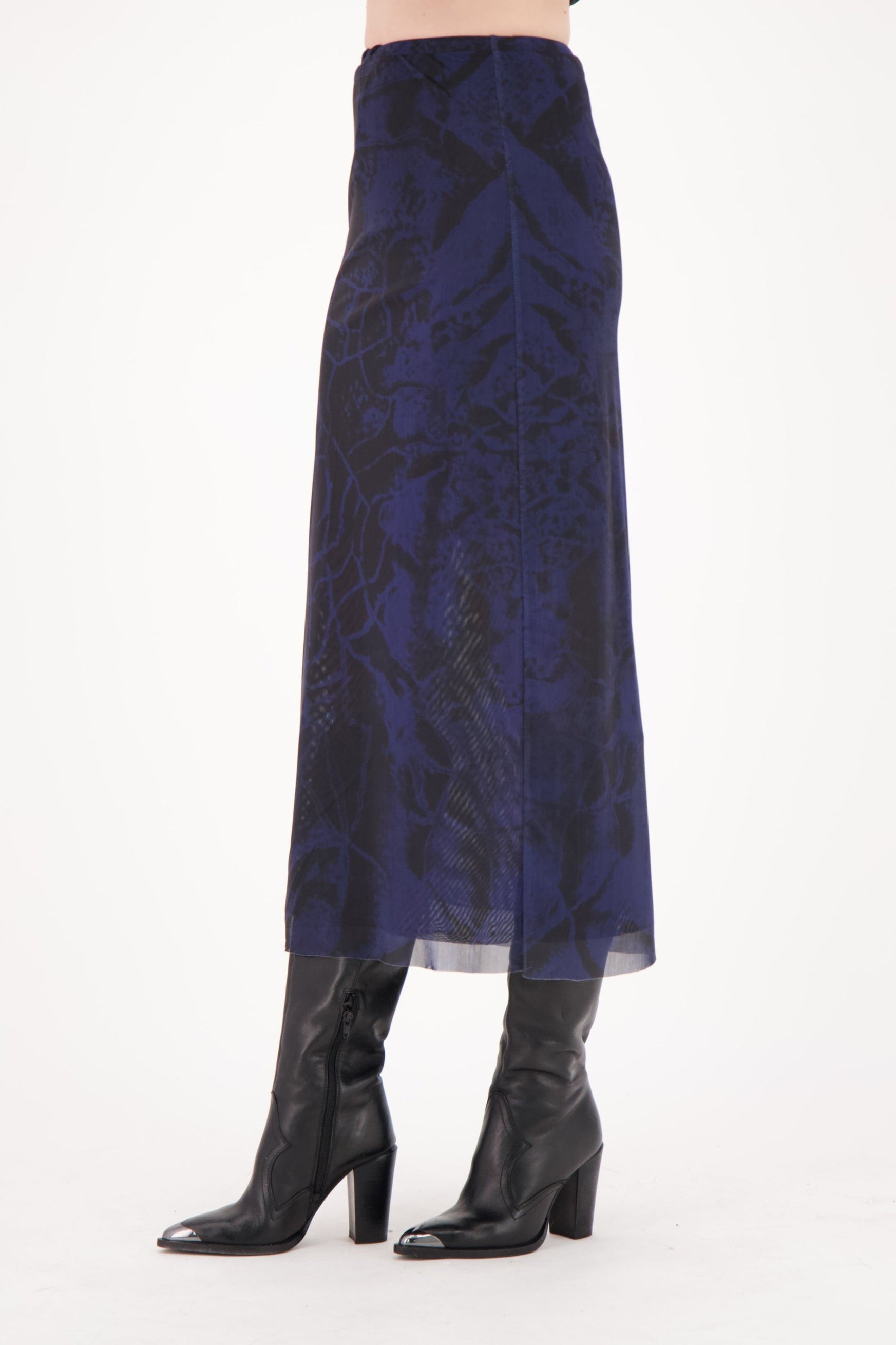 Navy patterned skirt worn by a person on a white background
