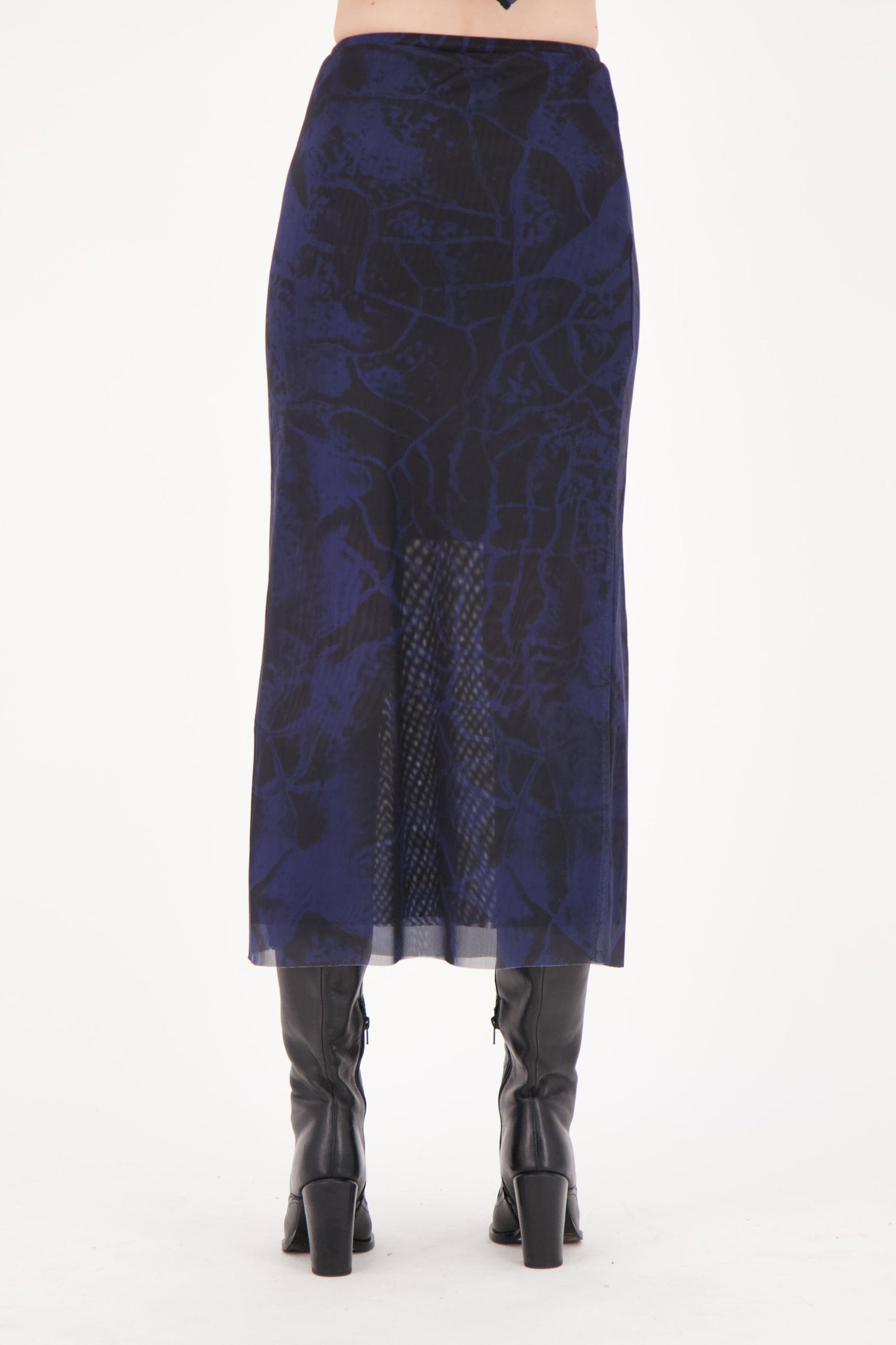 Navy blue patterned skirt worn by a person on a white background