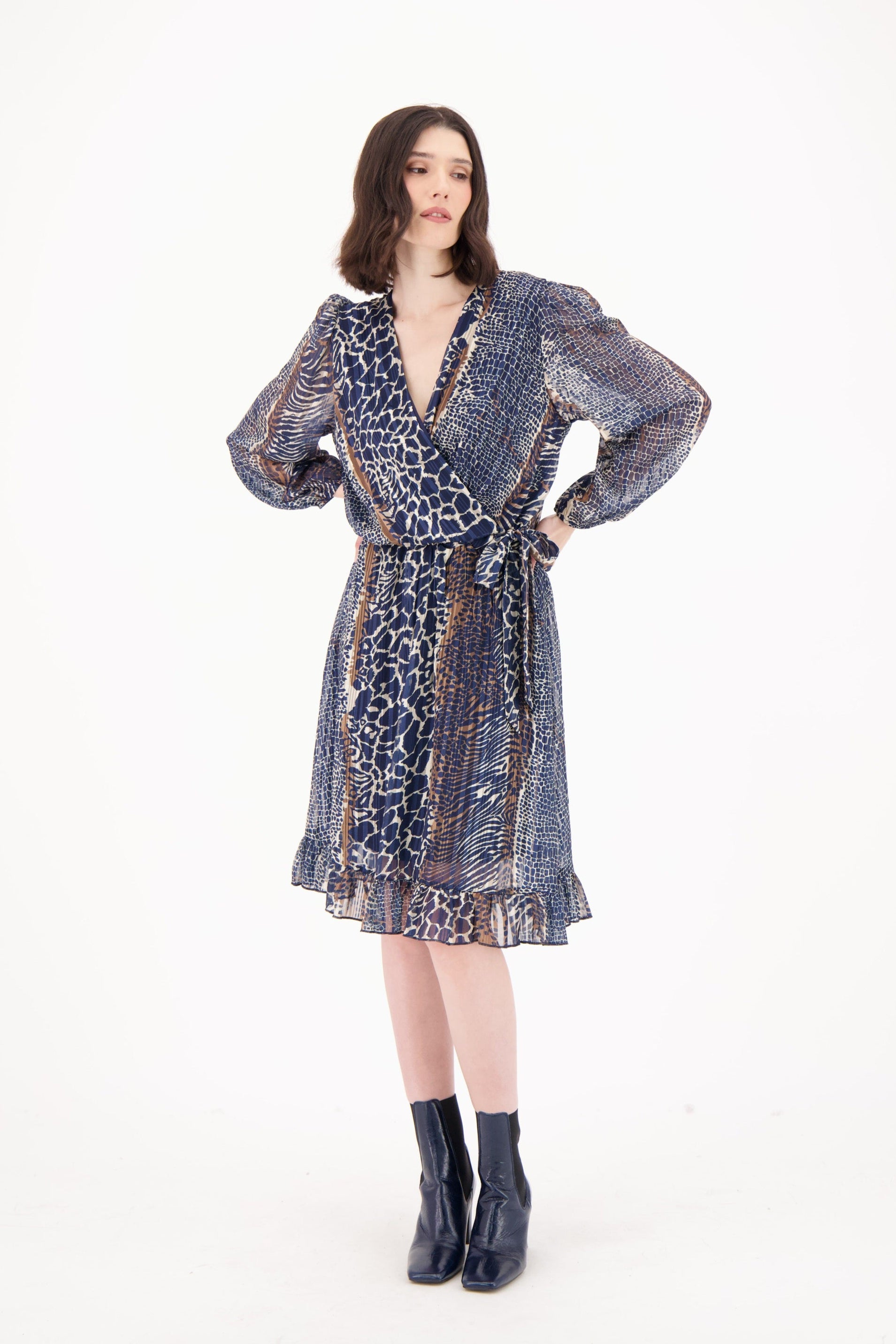 Woman wearing a patterned dress on a white background