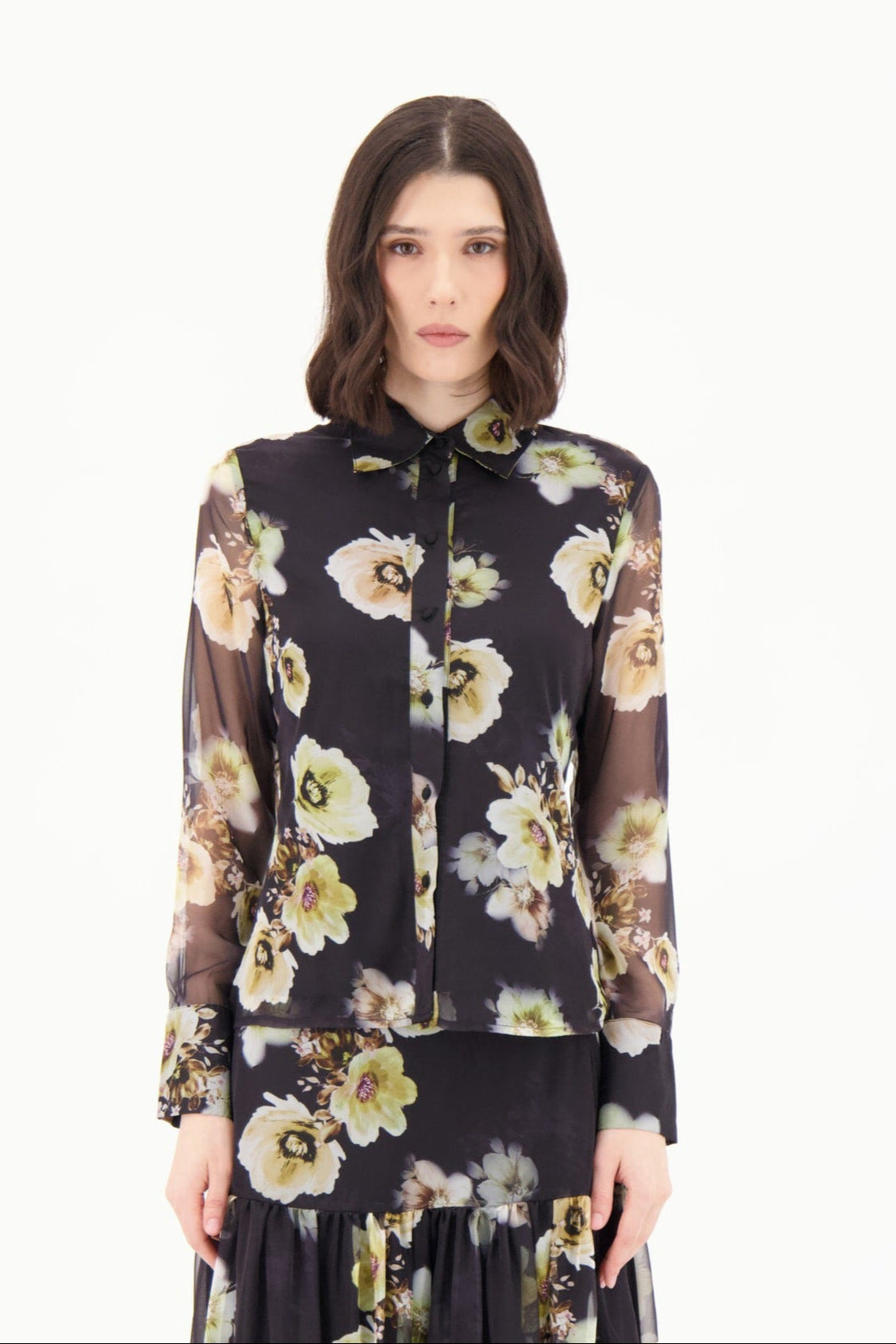 Woman wearing a floral blouse with a white background