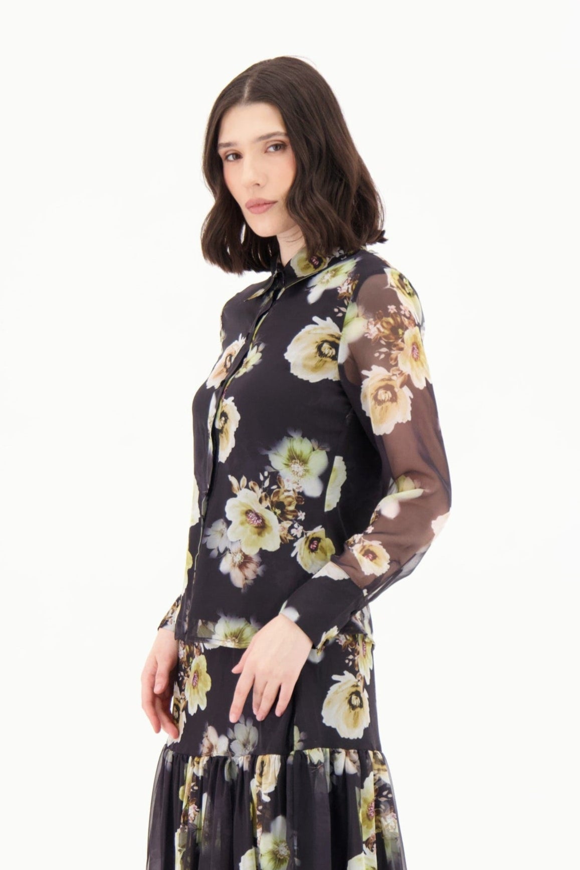 Woman wearing a black floral dress on a white background