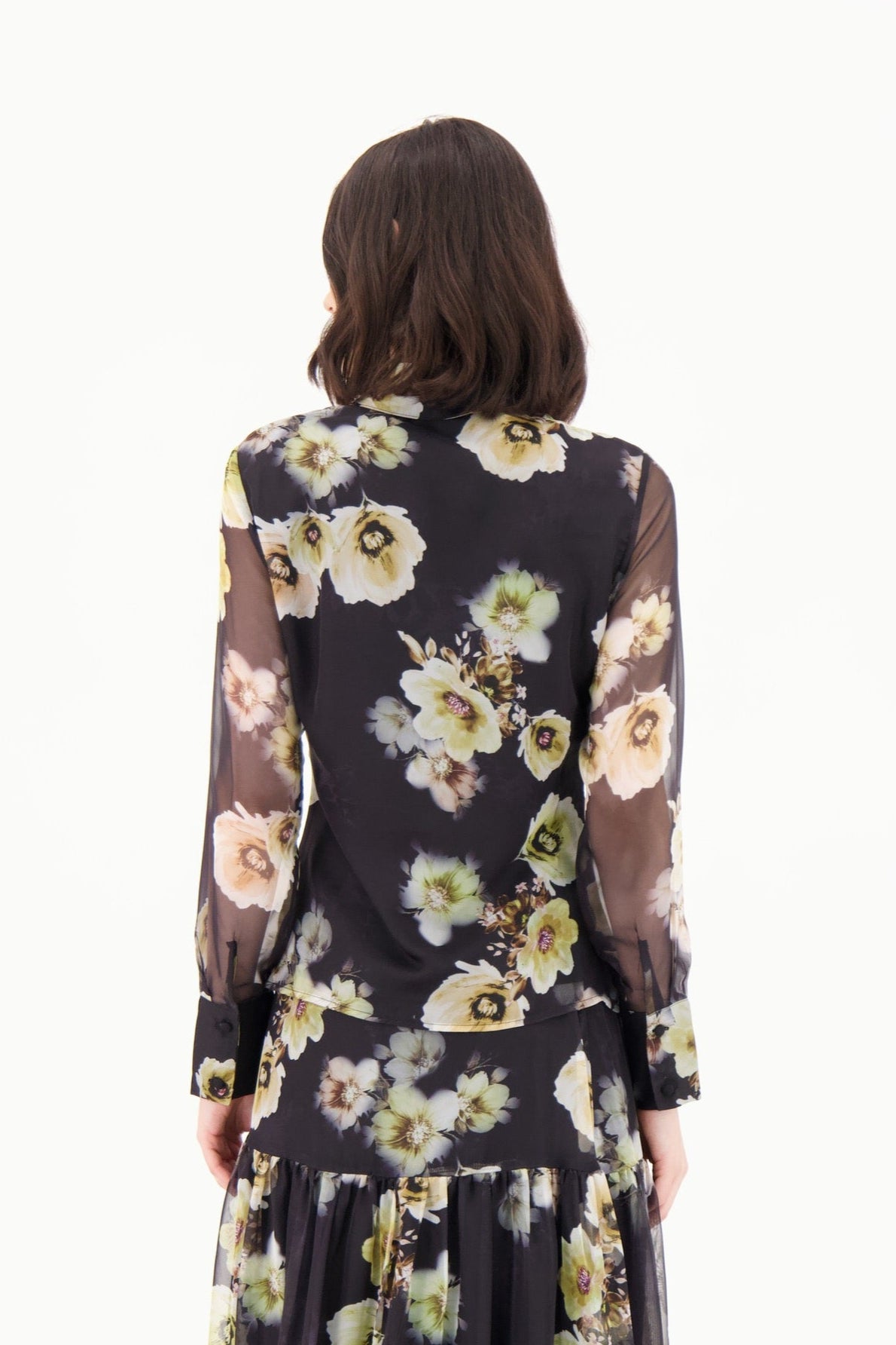 Woman wearing a floral dress with a white background