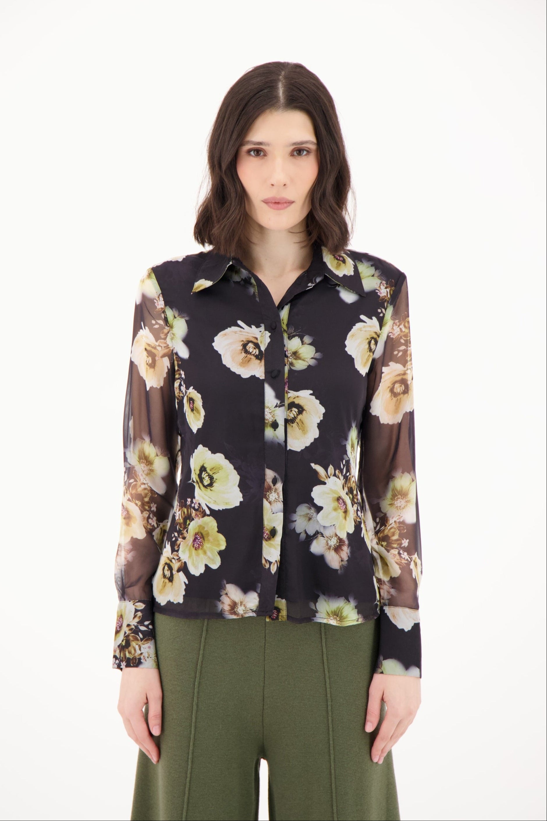 Woman wearing a floral blouse with a white background