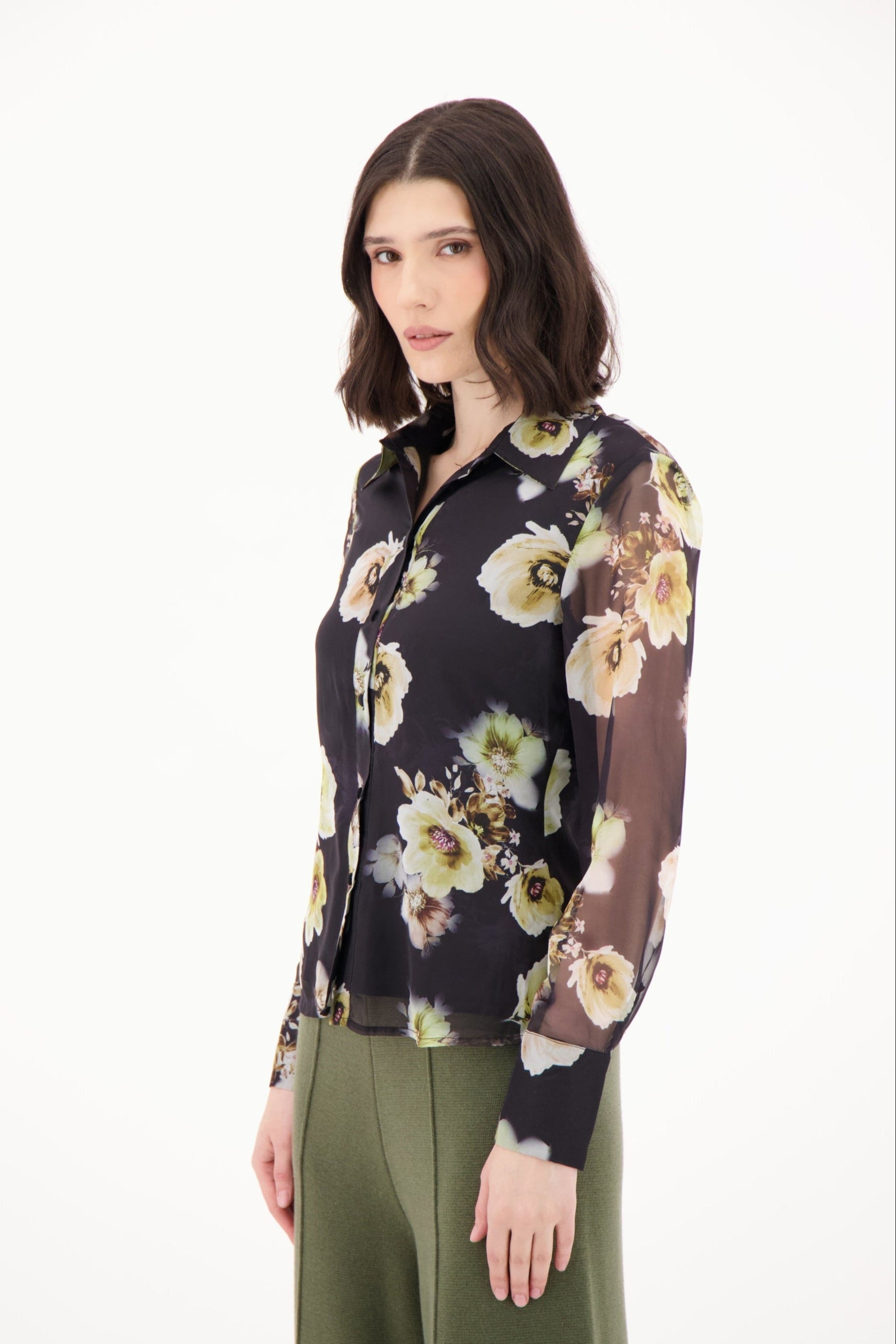 Woman wearing a floral blouse with a white background