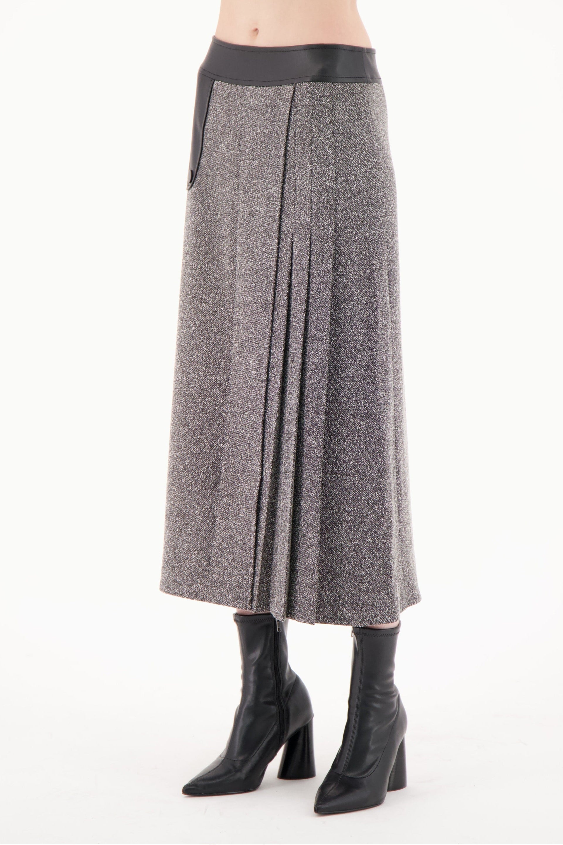 Gray pleated skirt worn by a person on a white background