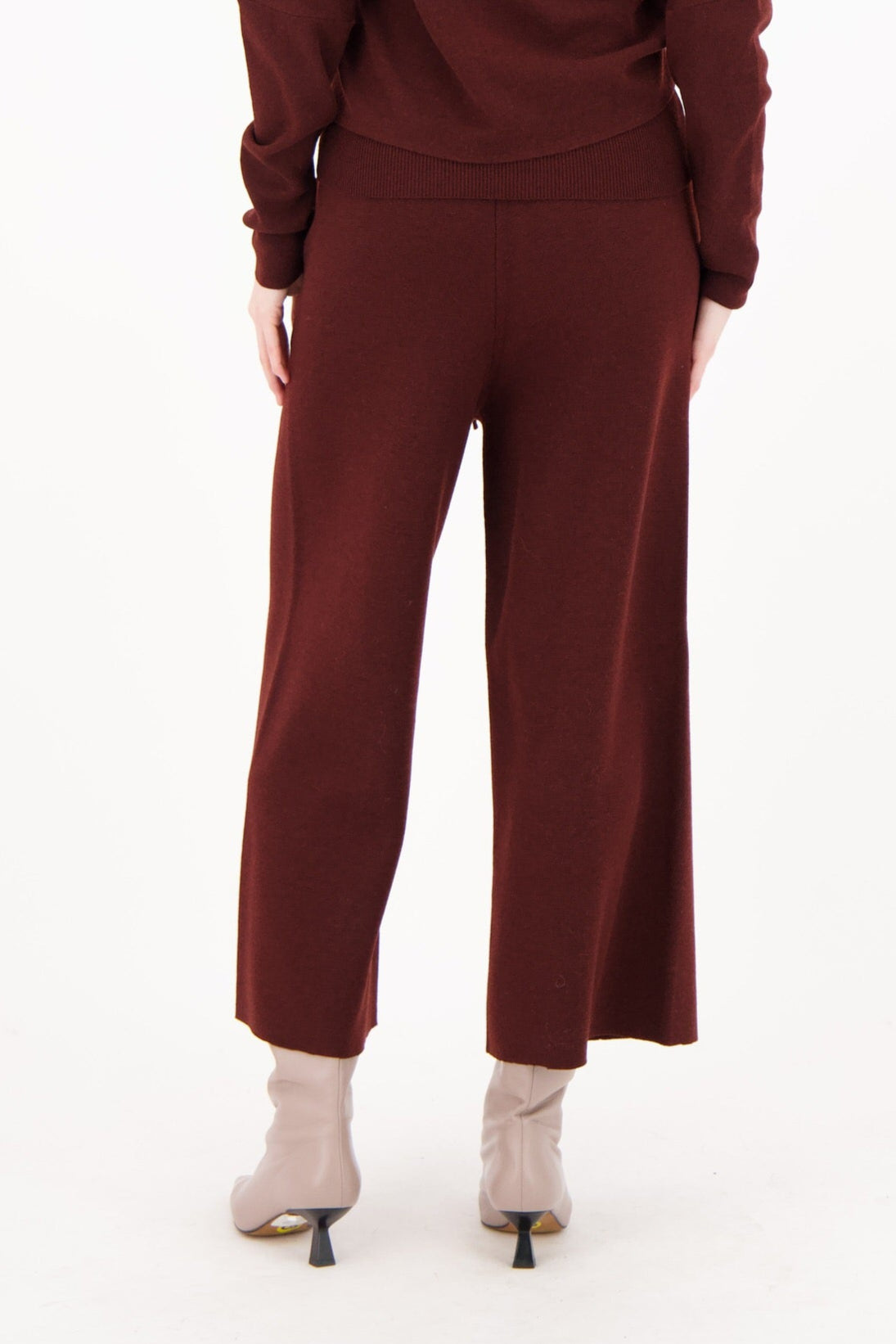 Woman wearing a brown outfit on a white background