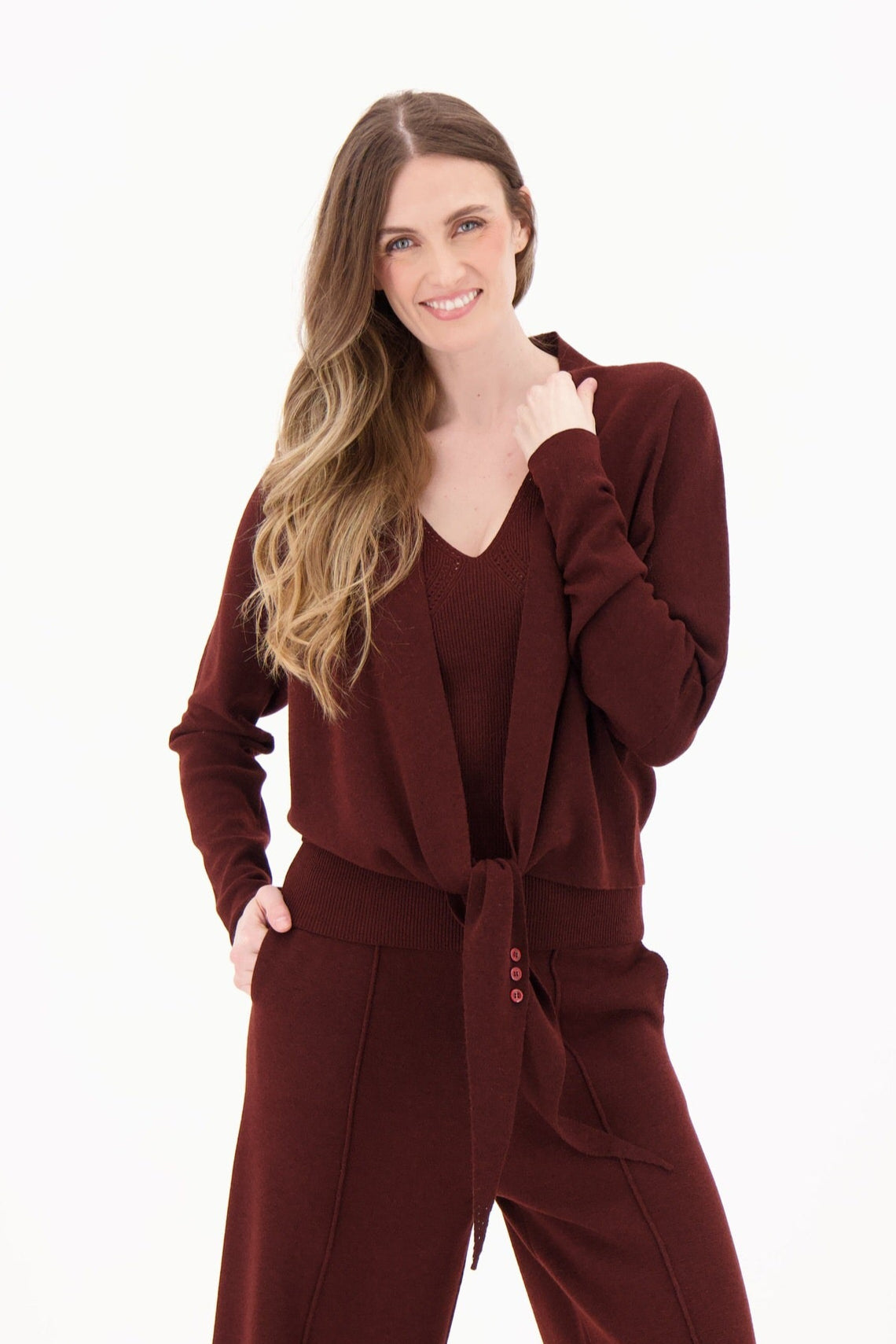 Woman wearing a maroon outfit on a white background