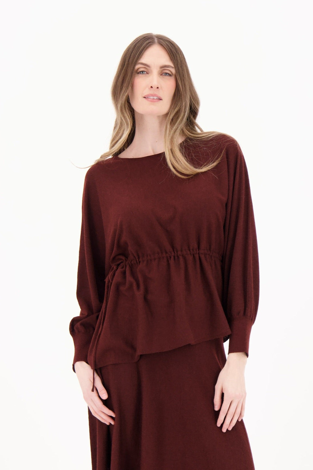 Woman wearing a burgundy dress on a white background
