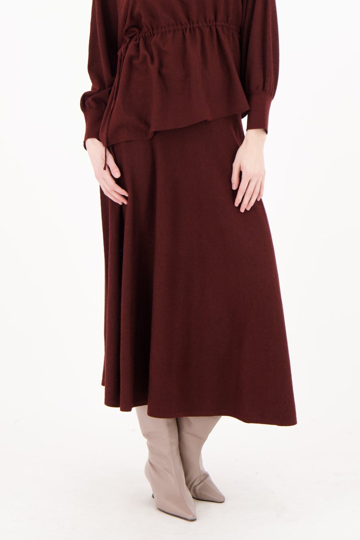 Woman wearing a burgundy dress on a white background