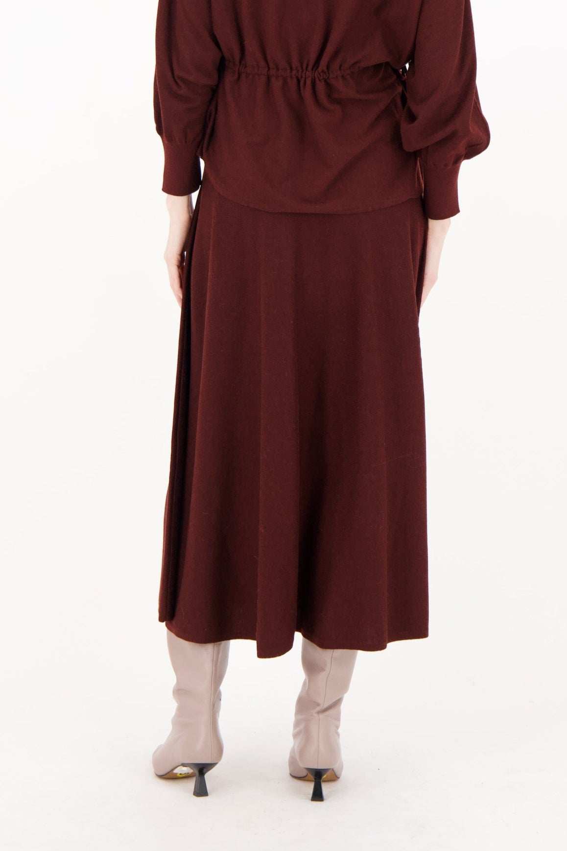 Woman wearing a burgundy dress on a white background