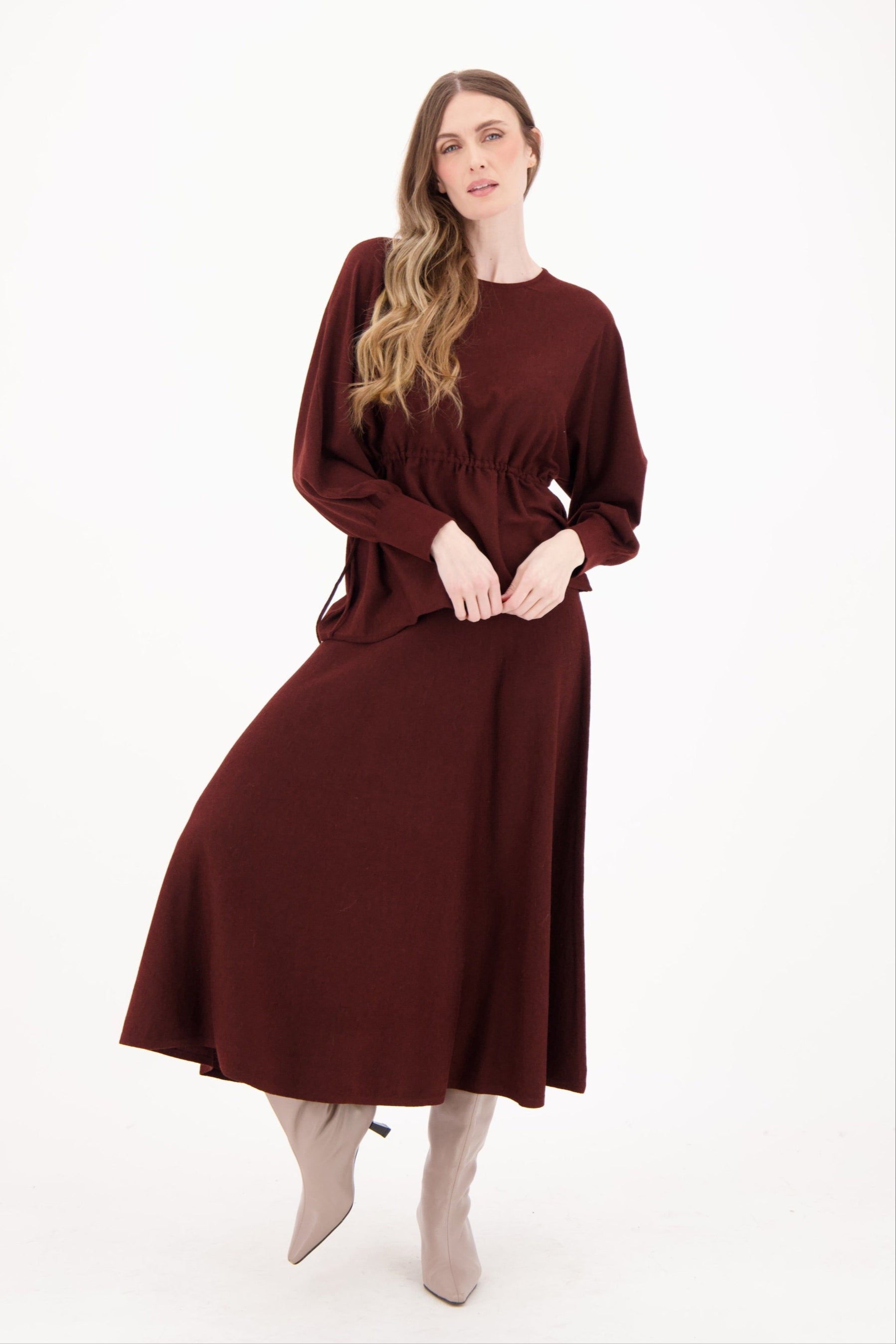 Woman wearing a burgundy dress on a white background