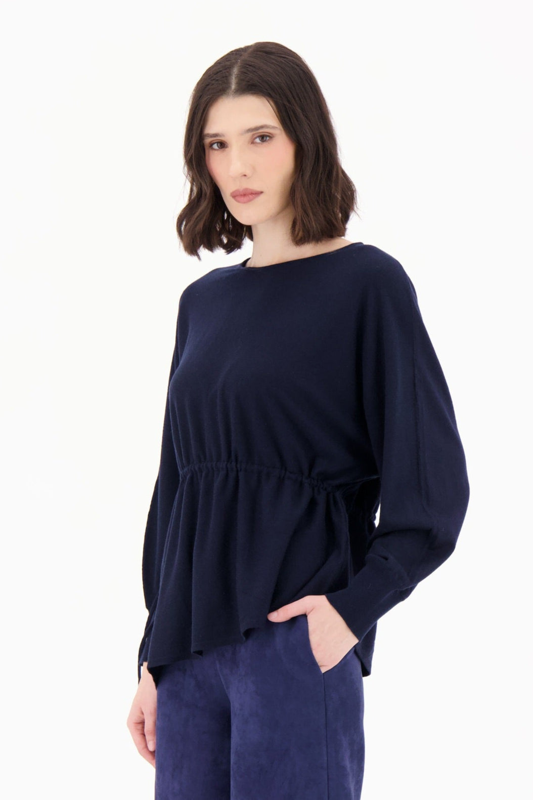 Woman wearing a navy blue outfit on a white background