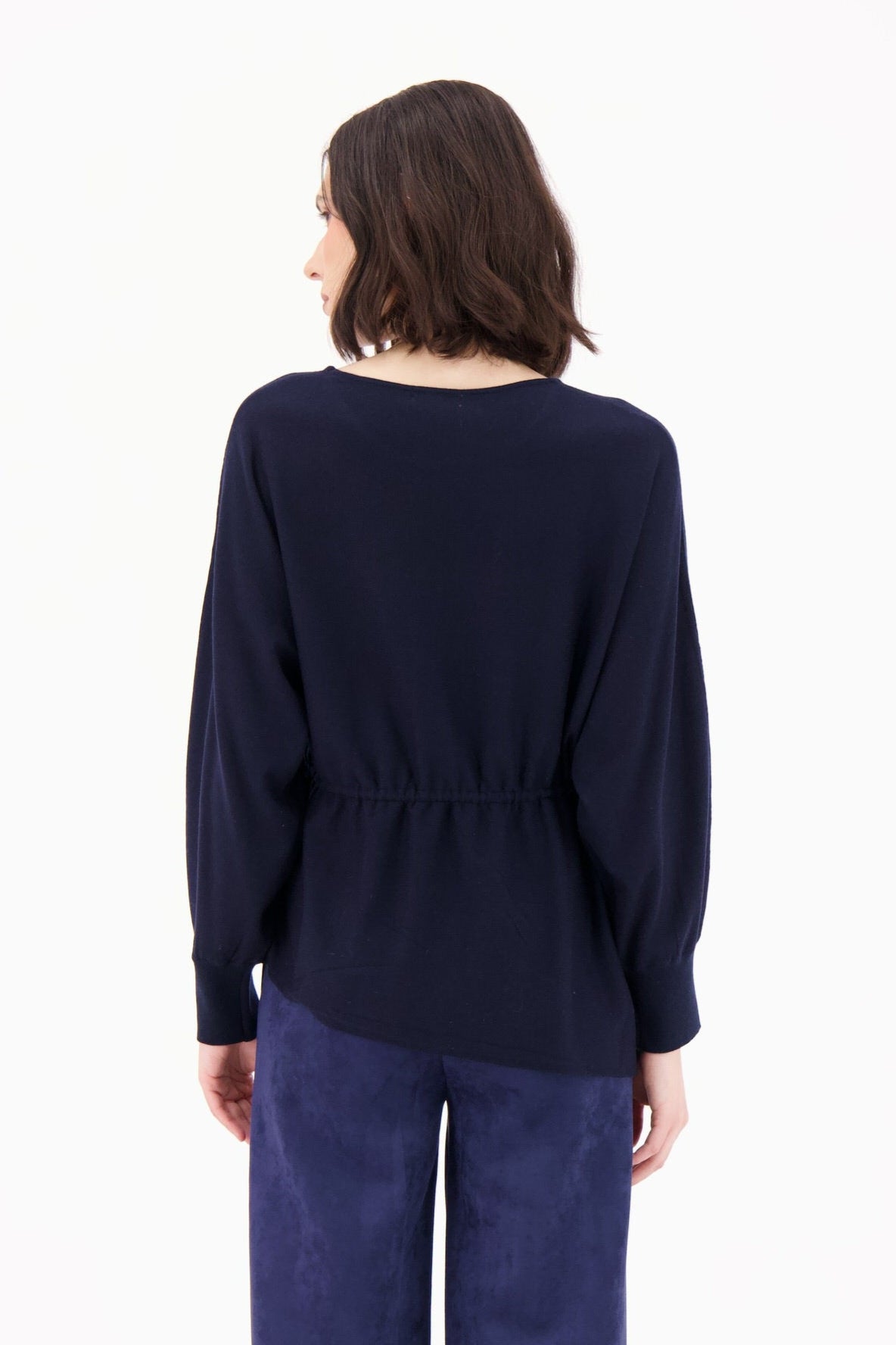 Person wearing a navy blue outfit on a white background