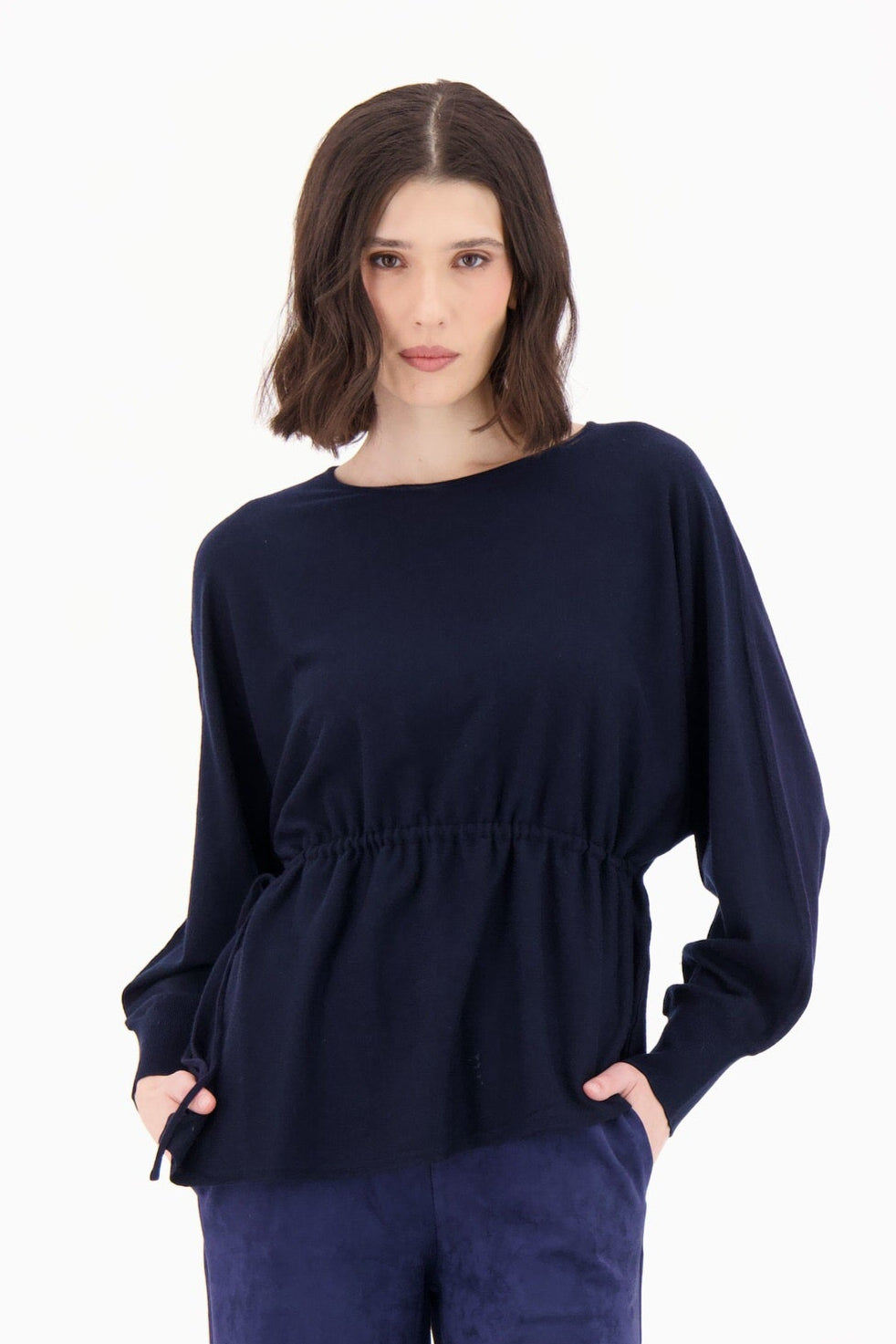 Woman wearing a navy blue outfit on a white background