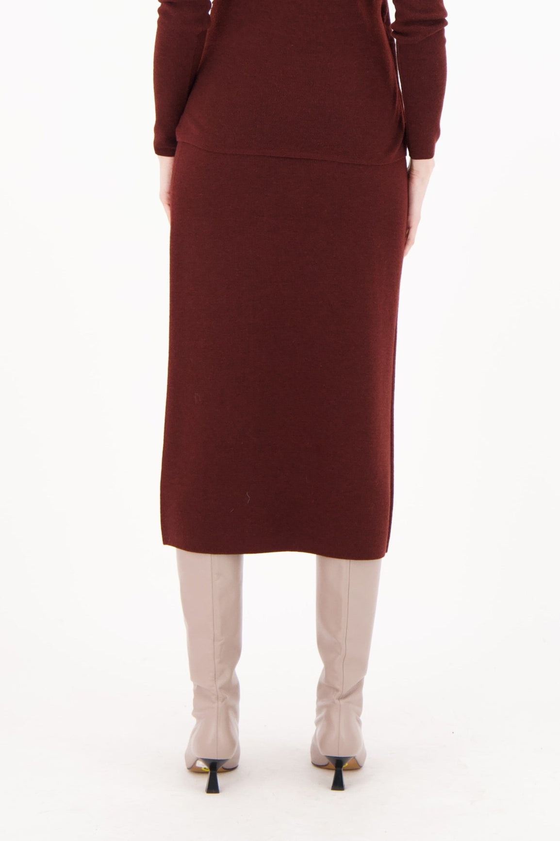 Woman wearing a burgundy dress on a white background