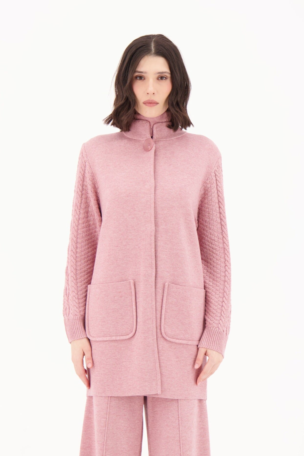 Woman wearing a pink outfit on a white background