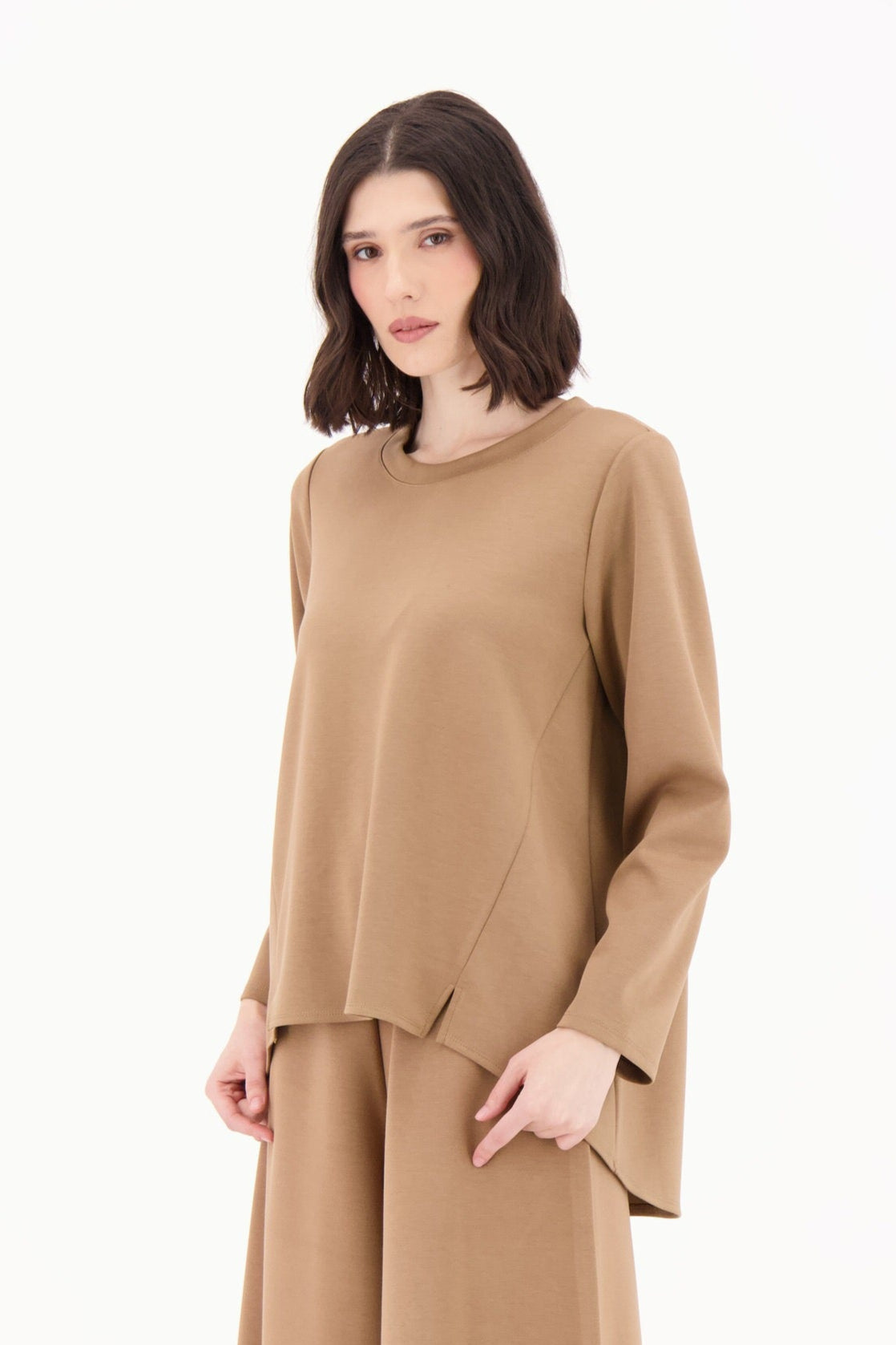 Woman wearing a beige outfit on a white background