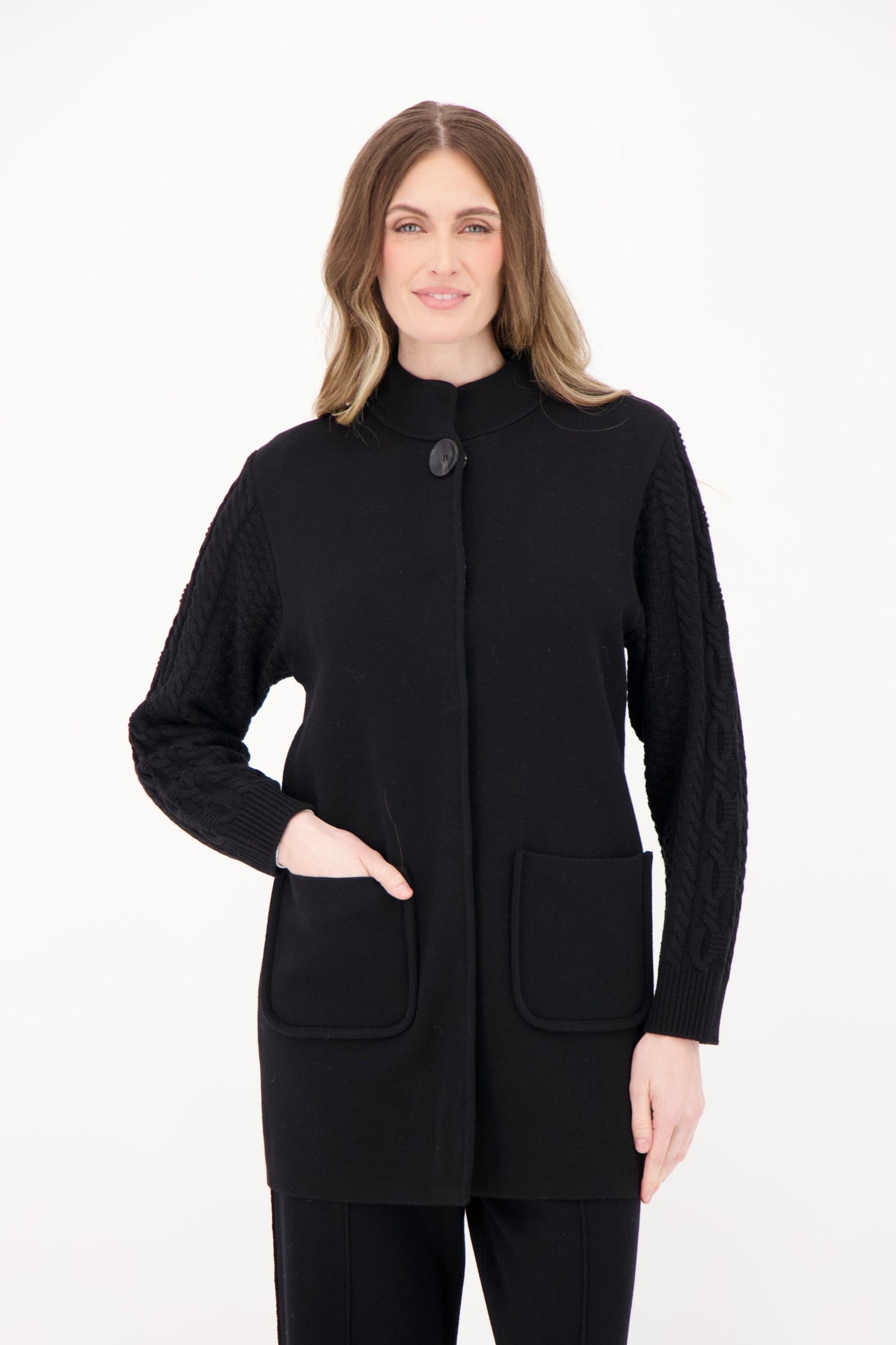 Woman wearing a black coat on a white background