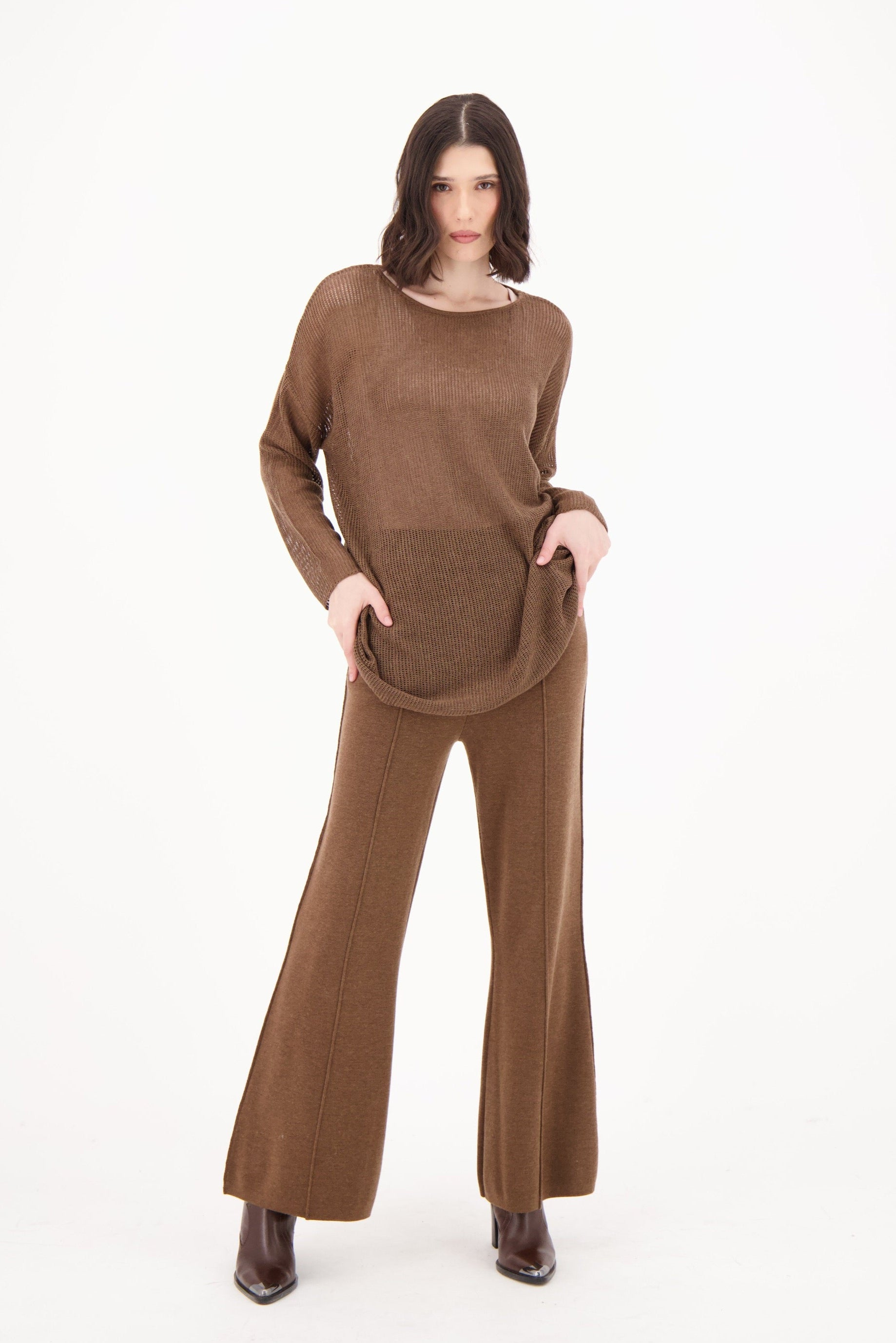 Woman wearing a brown outfit on a white background