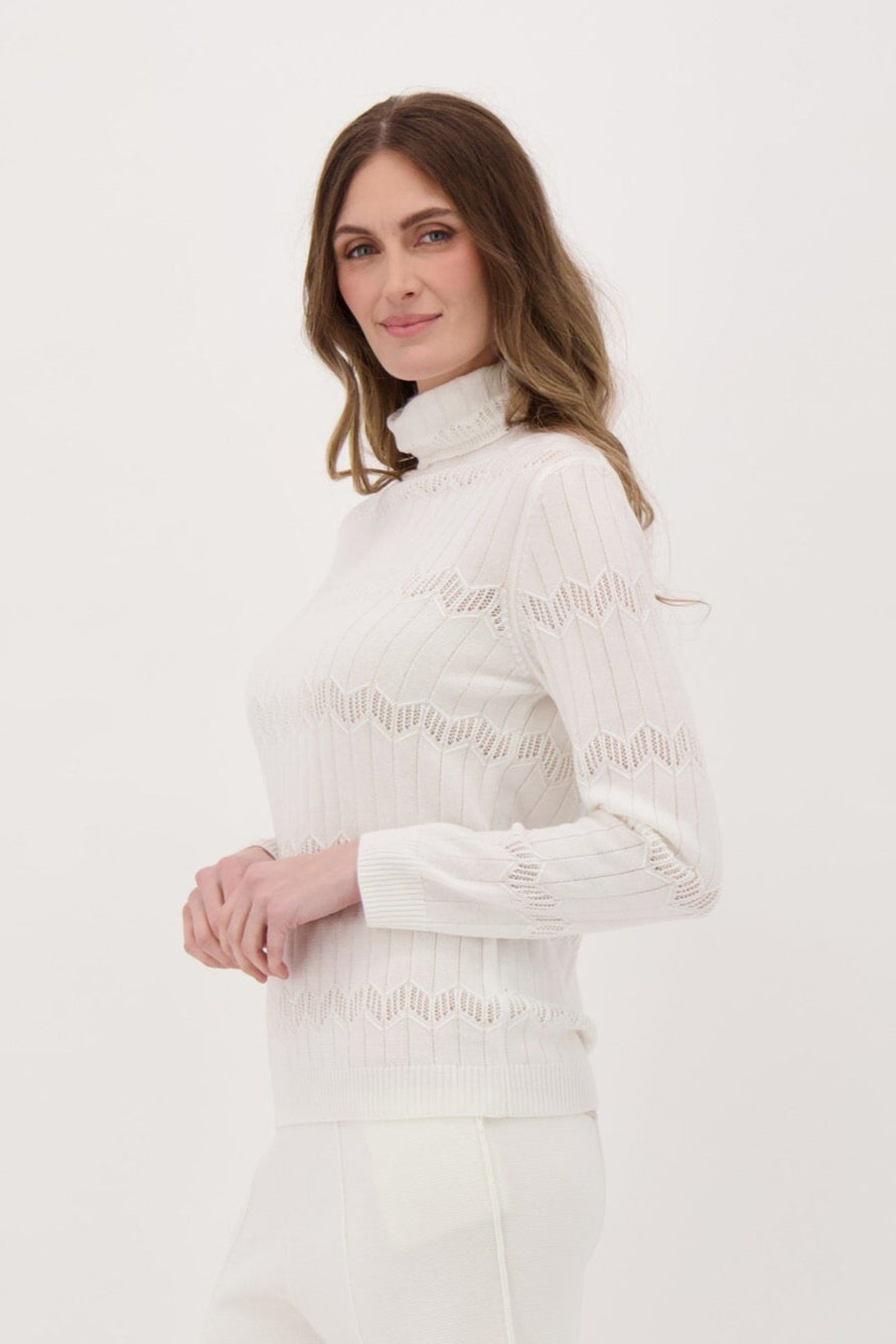 Person wearing a white outfit on a plain background