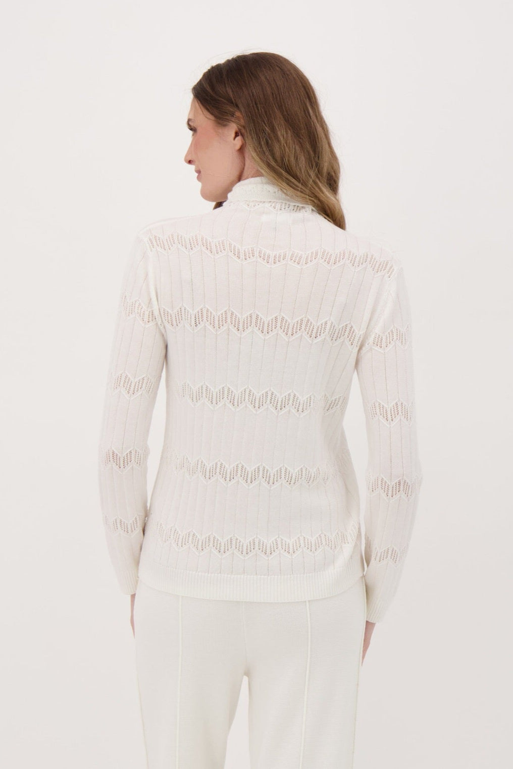 Person wearing a white puffer jacket and pants on a white background