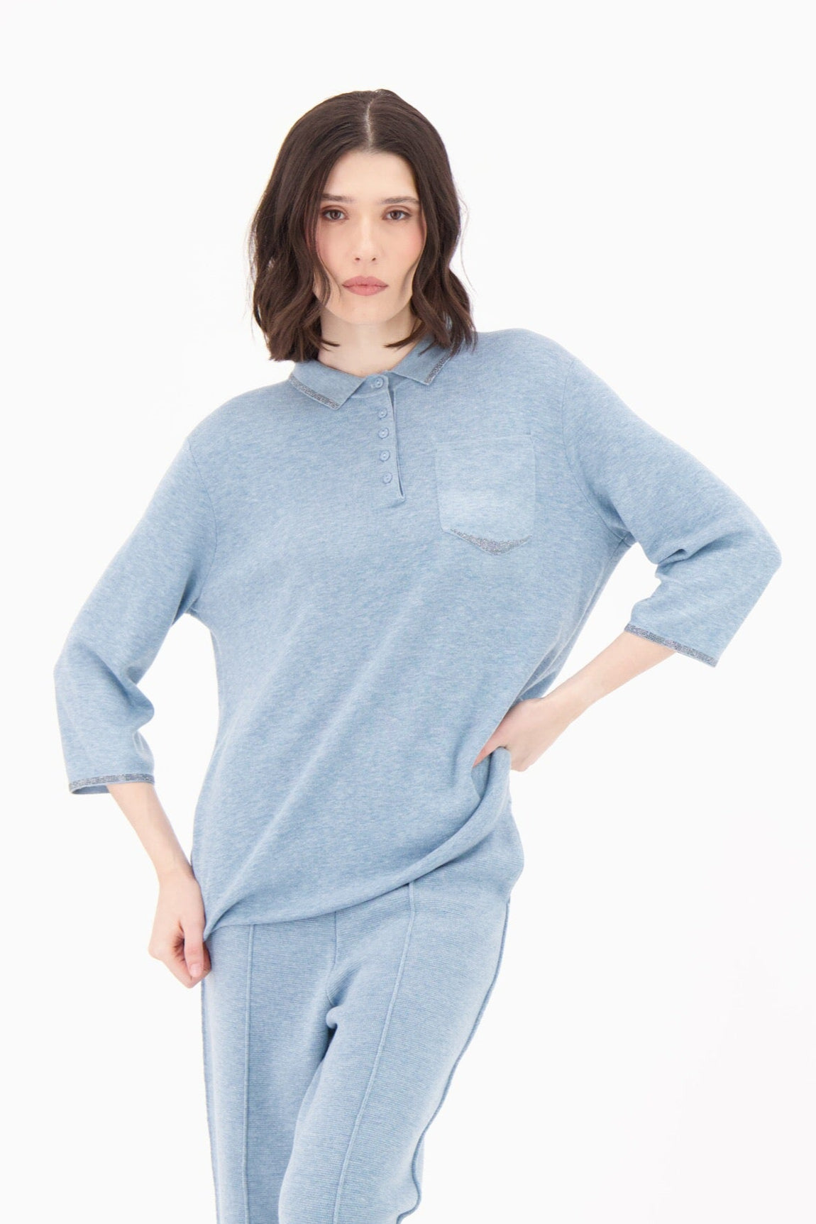 Woman wearing a light blue outfit on a white background