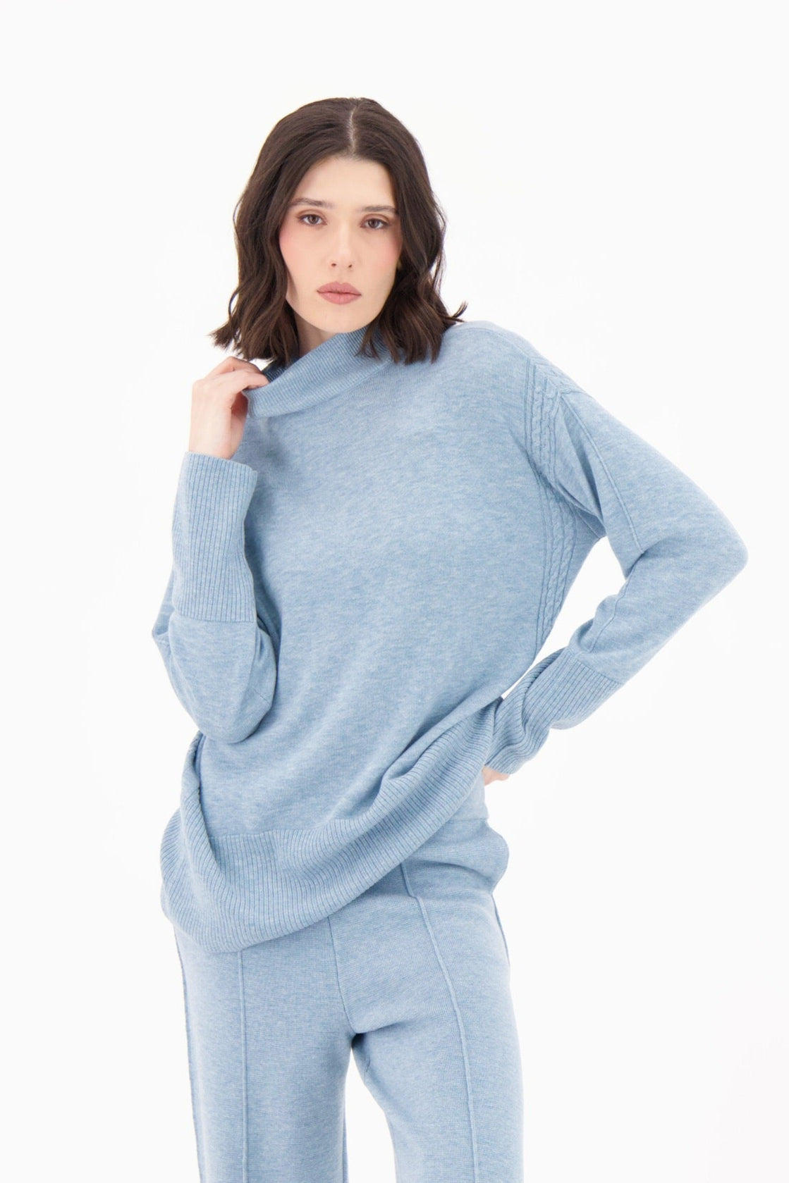 Woman wearing a light blue outfit on a white background