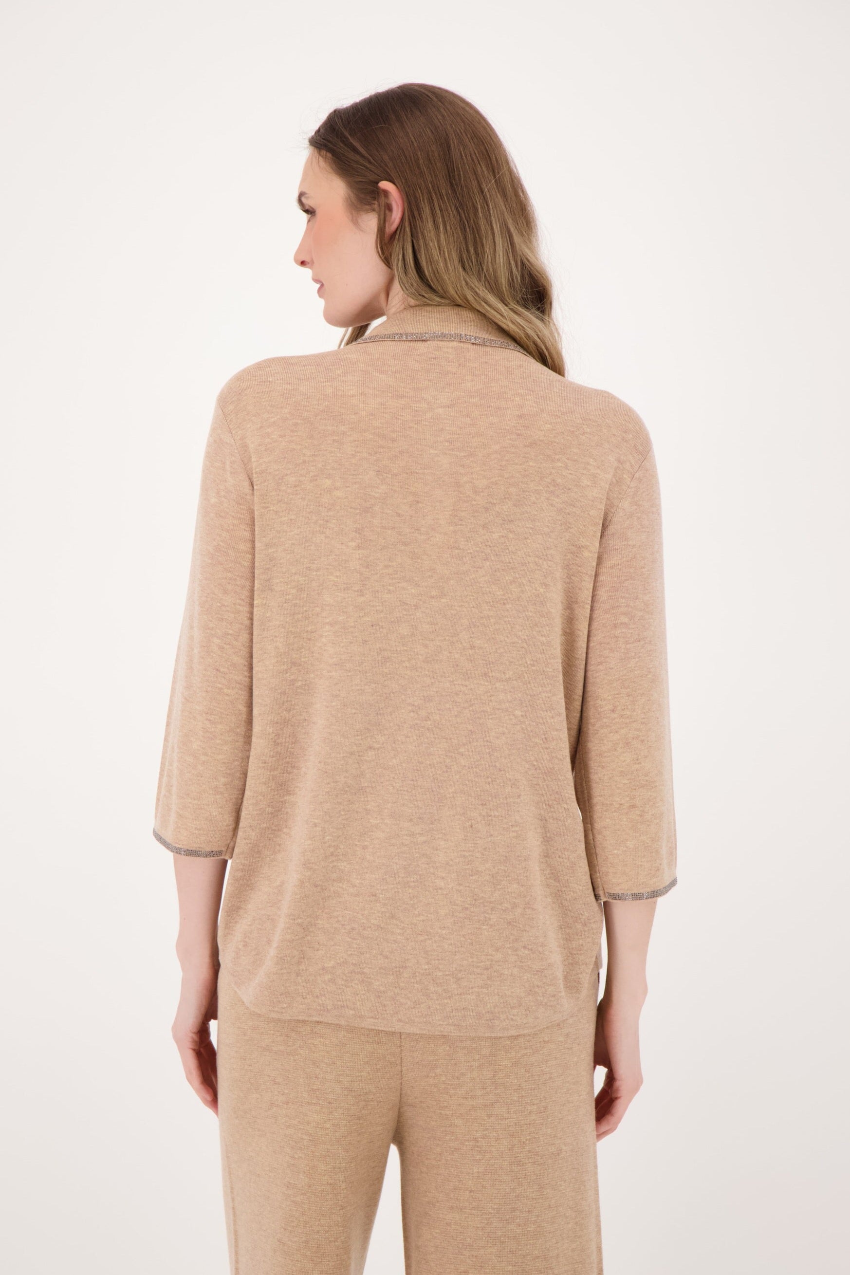Woman wearing a beige outfit on a white background