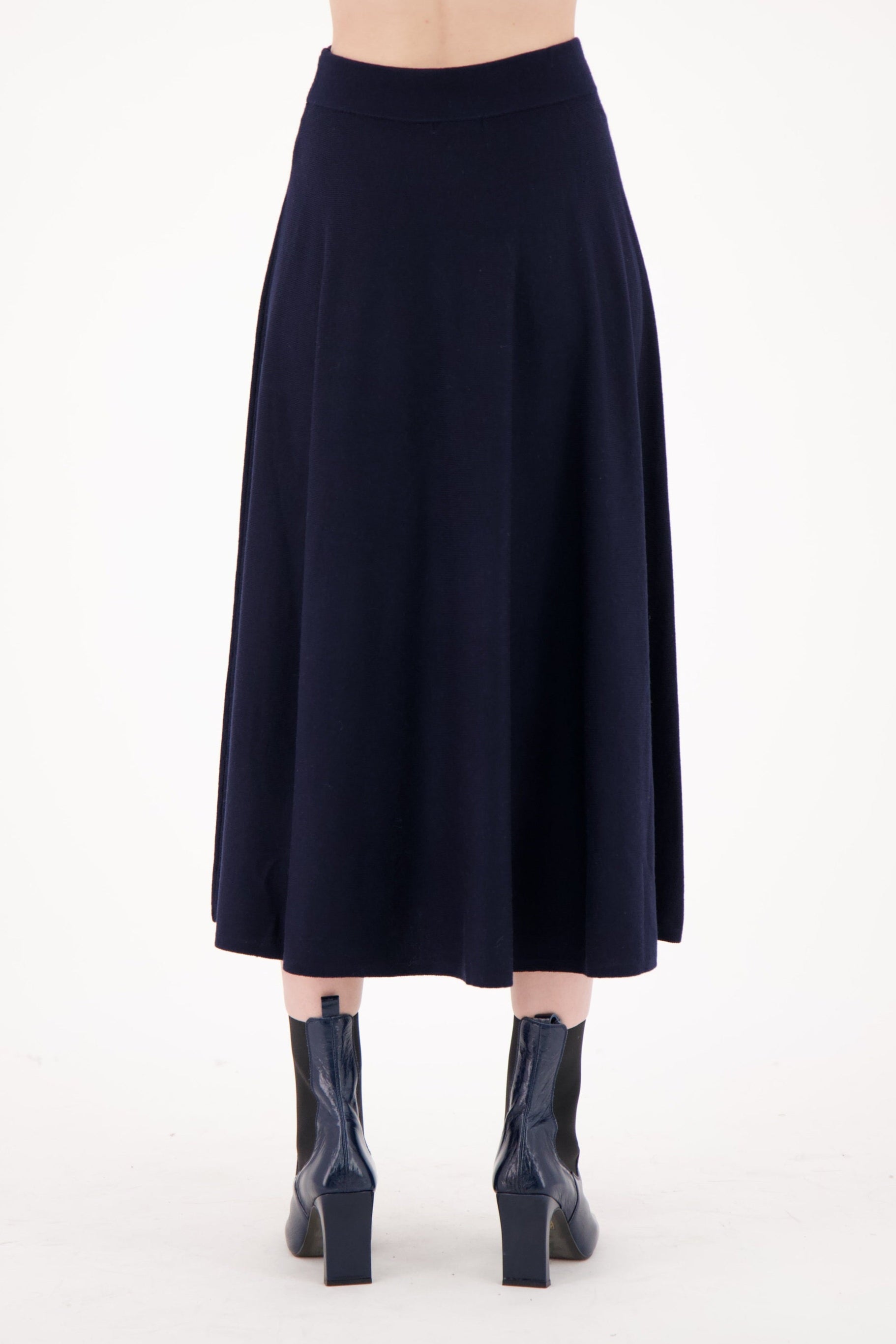 Navy blue skirt worn by a person on a white background