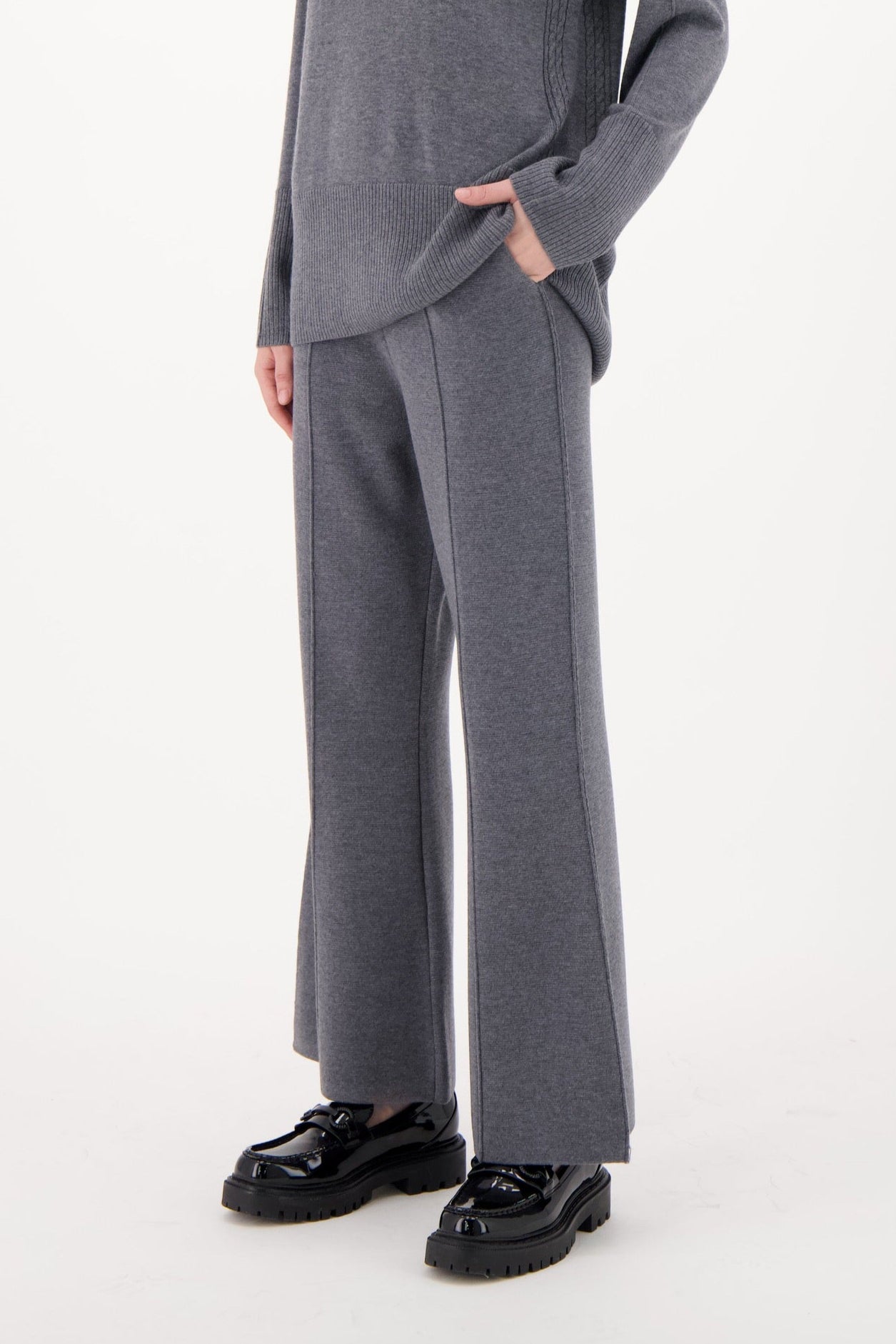 Woman wearing a gray outfit on a white background