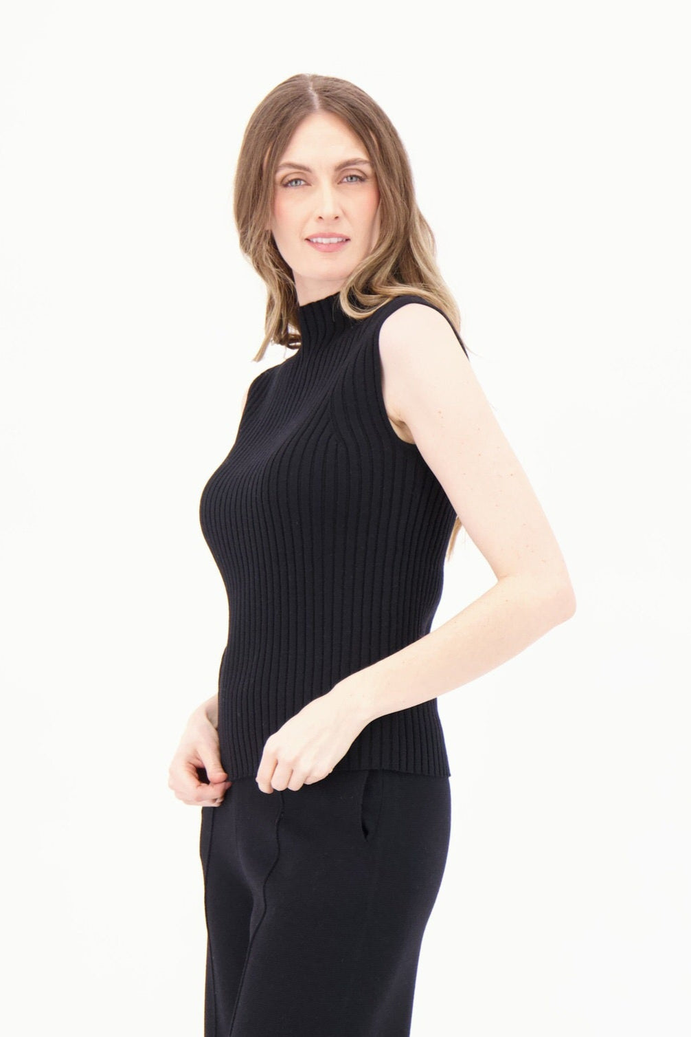 Woman wearing a black sleeveless dress on a white background