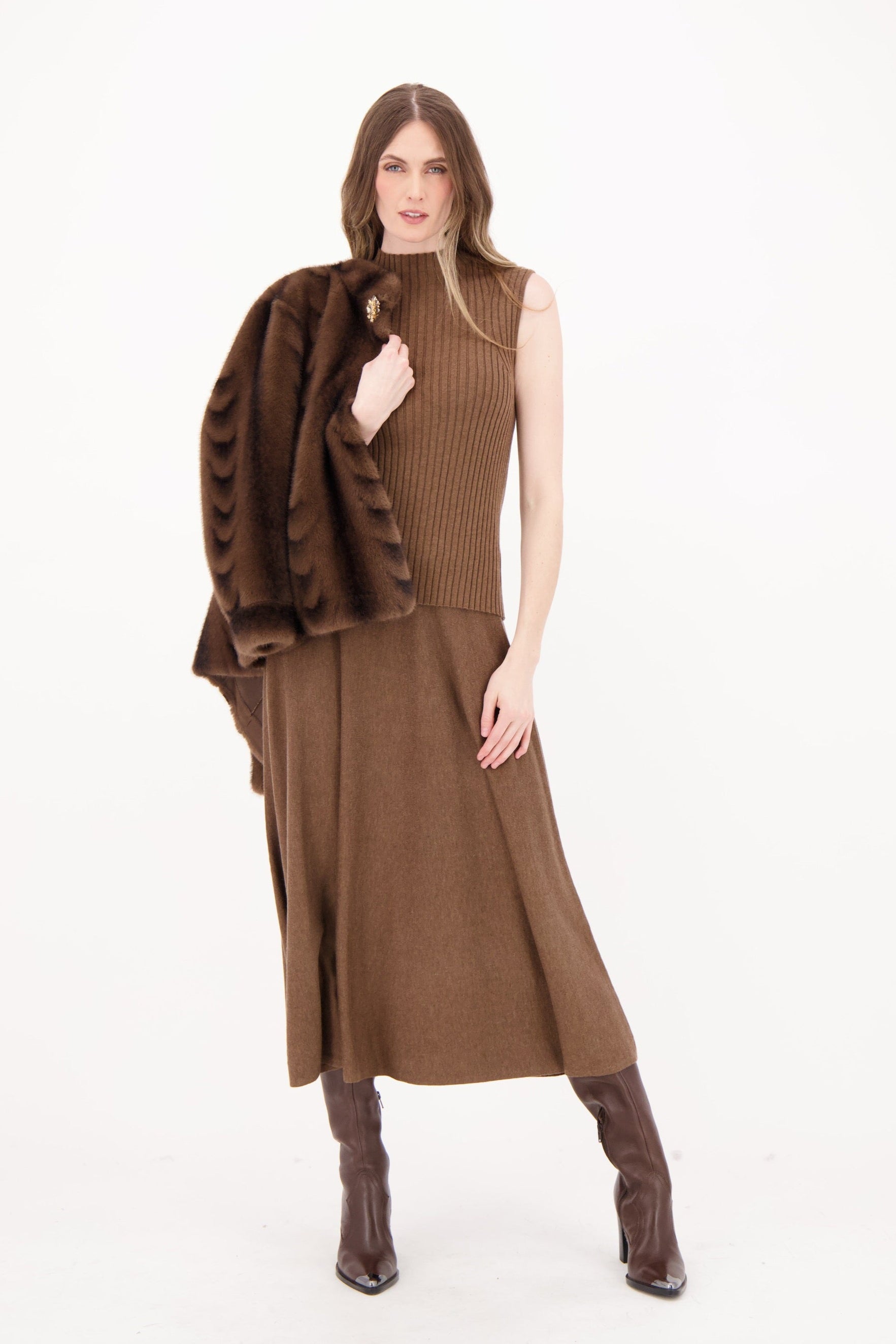 Woman wearing a brown dress with a matching jacket on a white background