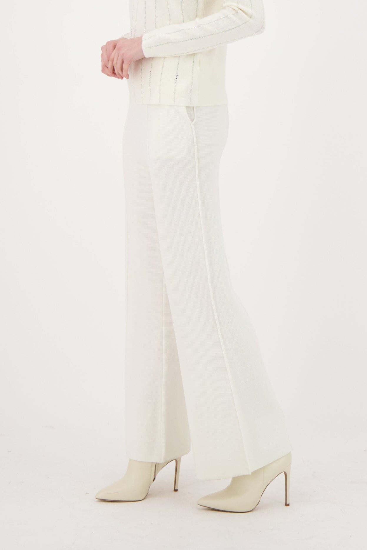 Woman wearing a white outfit on a white background