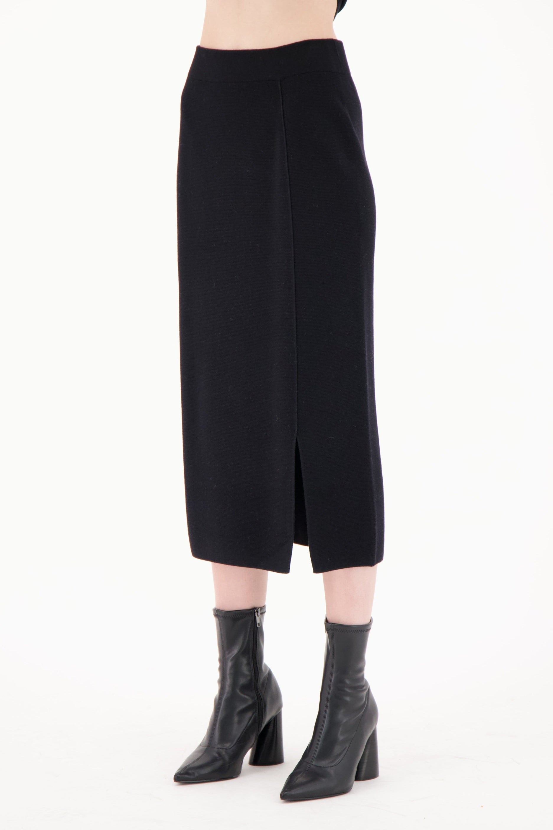 Black skirt worn by a person on a white background