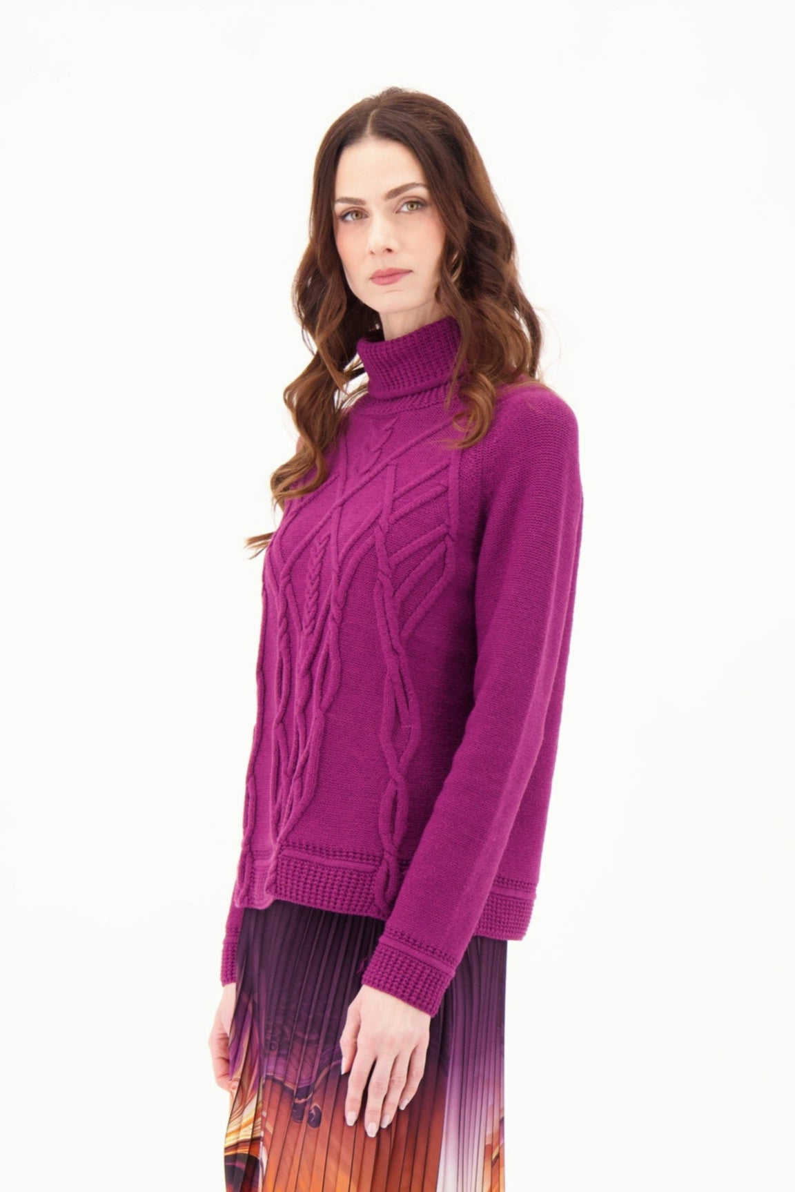 Woman wearing a purple cable knit sweater on a white background