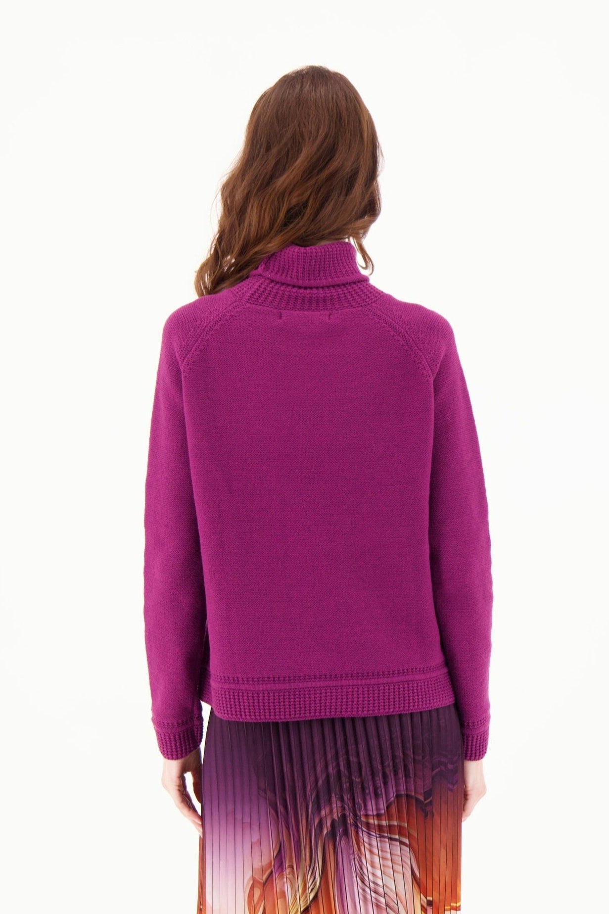 Person wearing a purple sweater on a white background