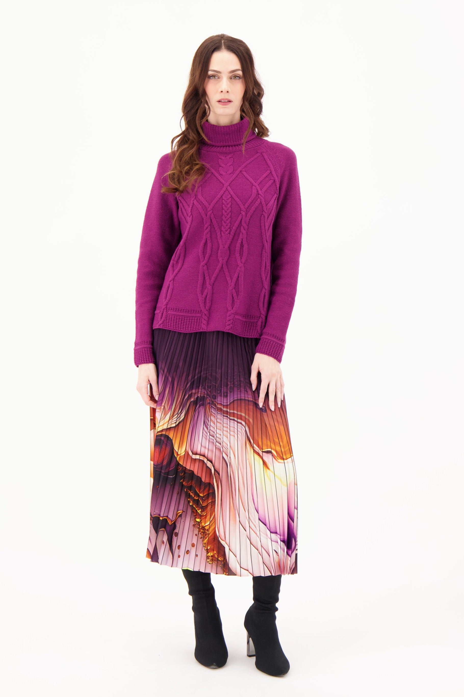 Woman wearing a purple sweater and colorful skirt on a white background