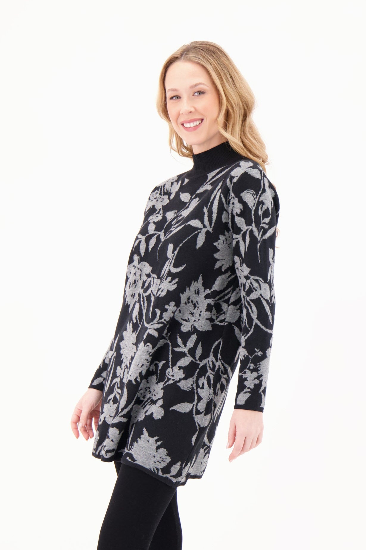 Woman wearing a black floral dress on a white background