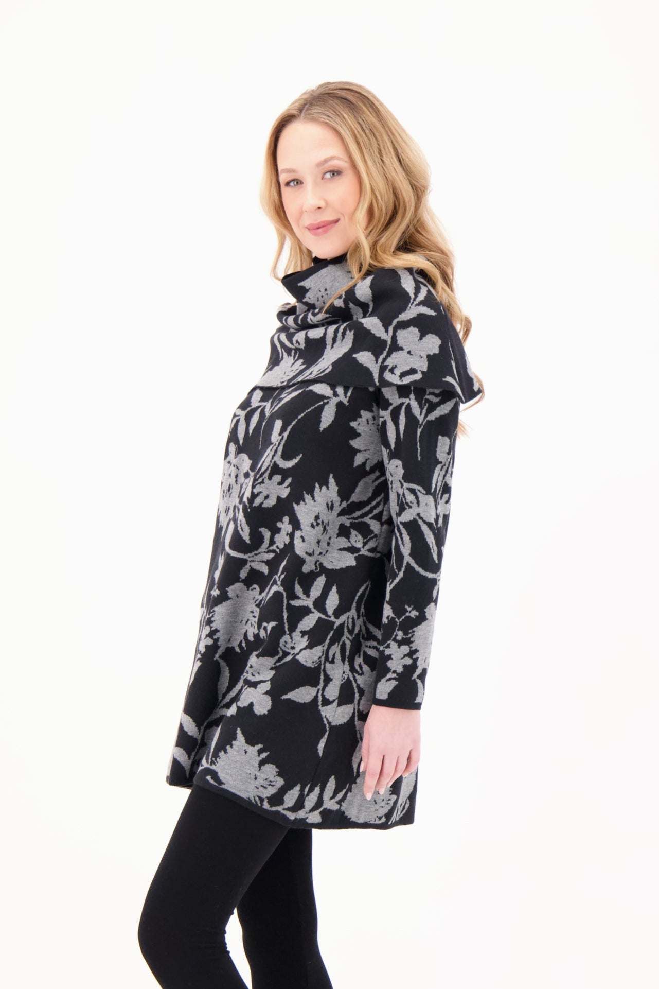 Woman wearing a floral patterned coat on a white background