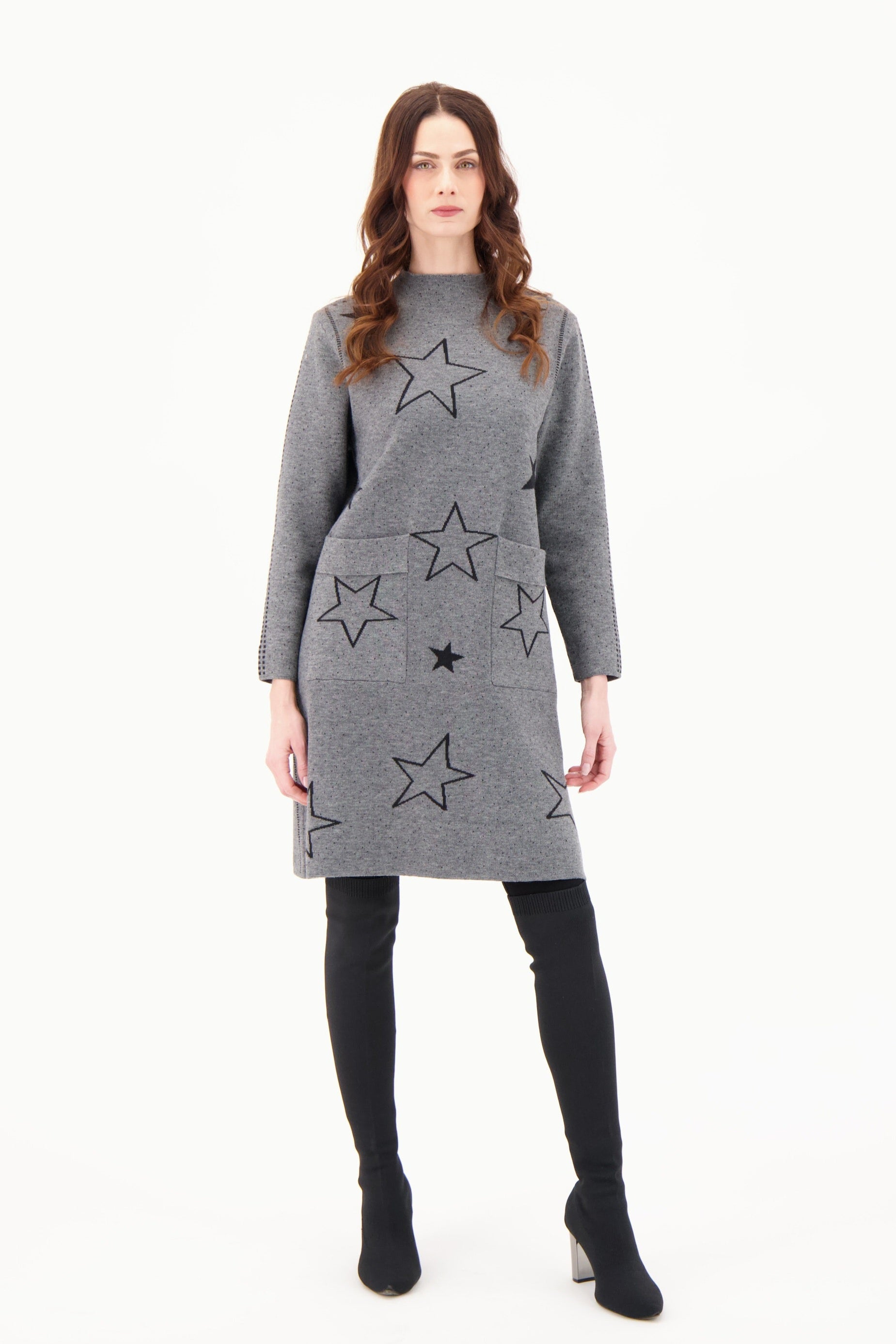 Woman wearing a gray dress with star patterns on a white background