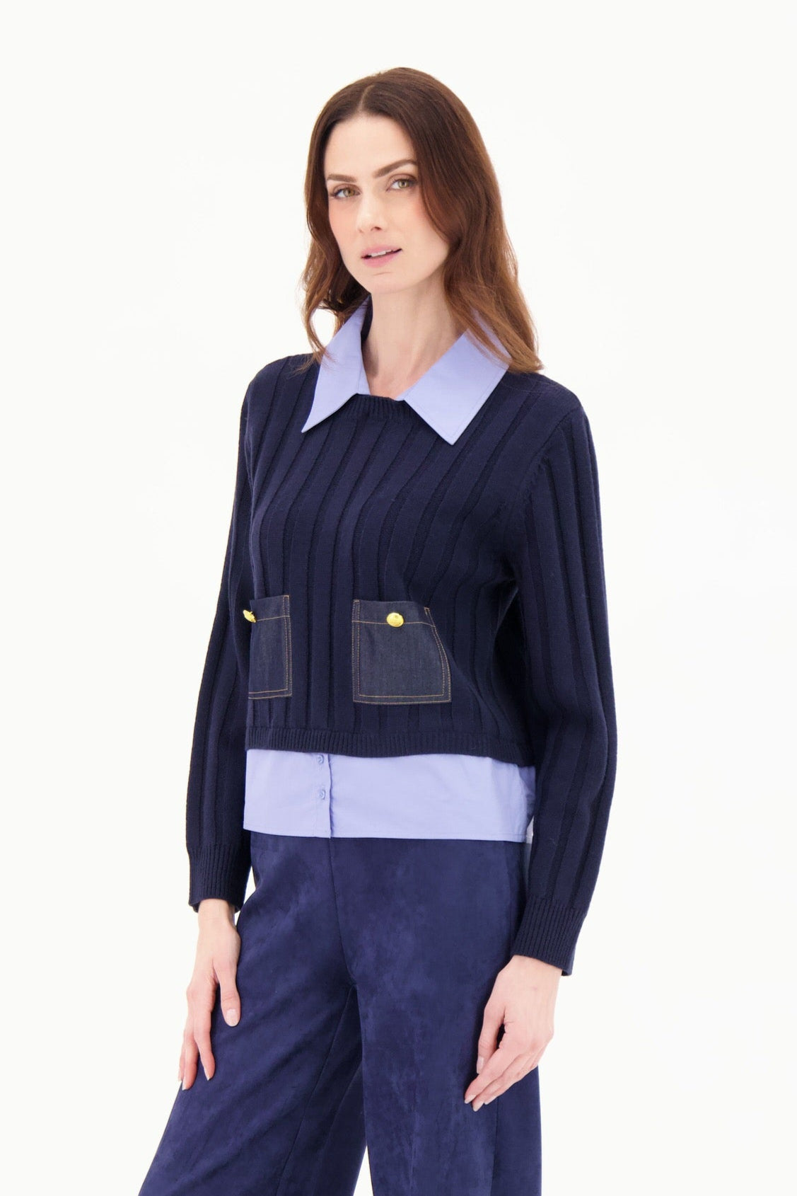 Woman wearing a navy blue outfit with a white background