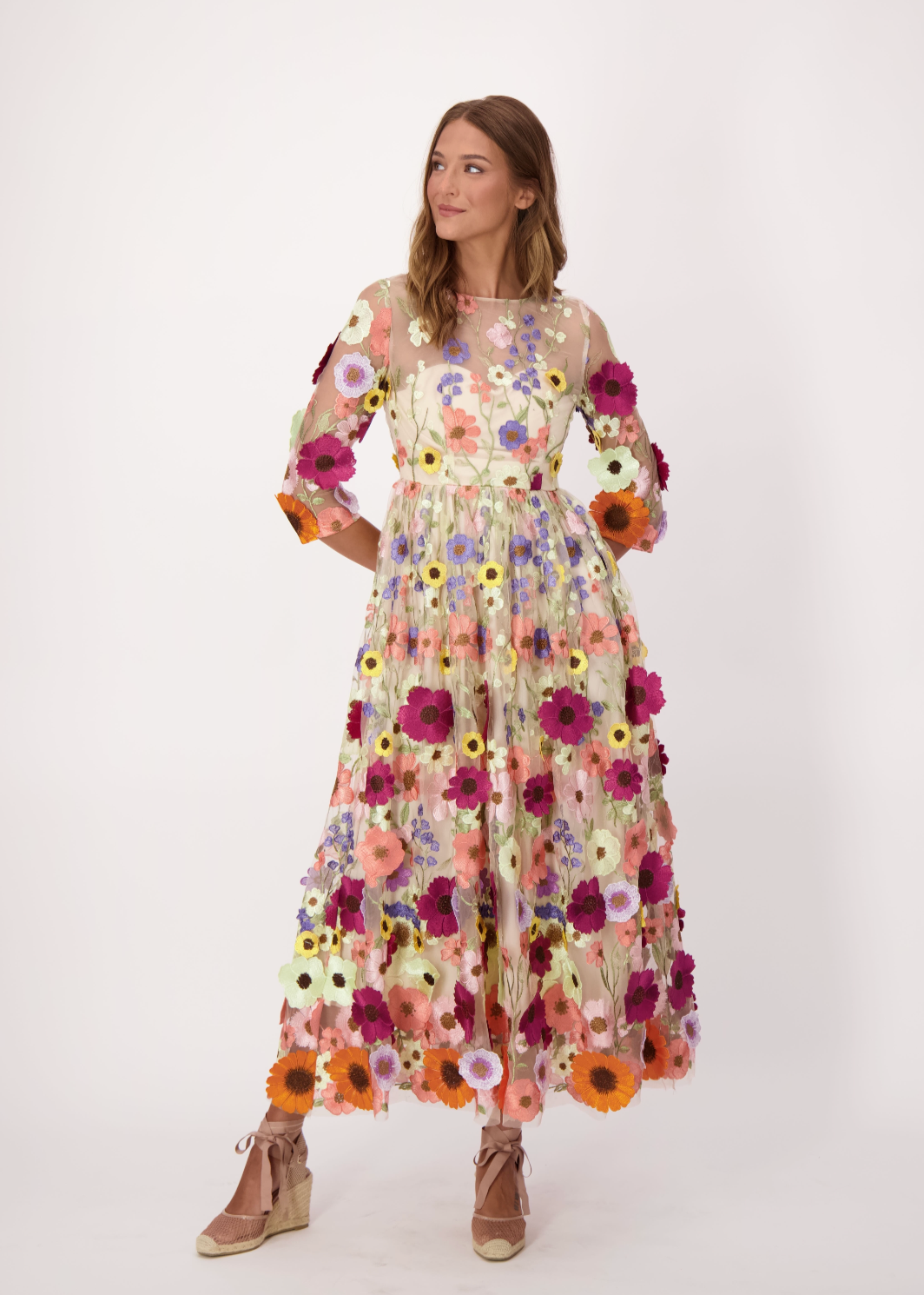 Woman wearing a floral dress on a white background
