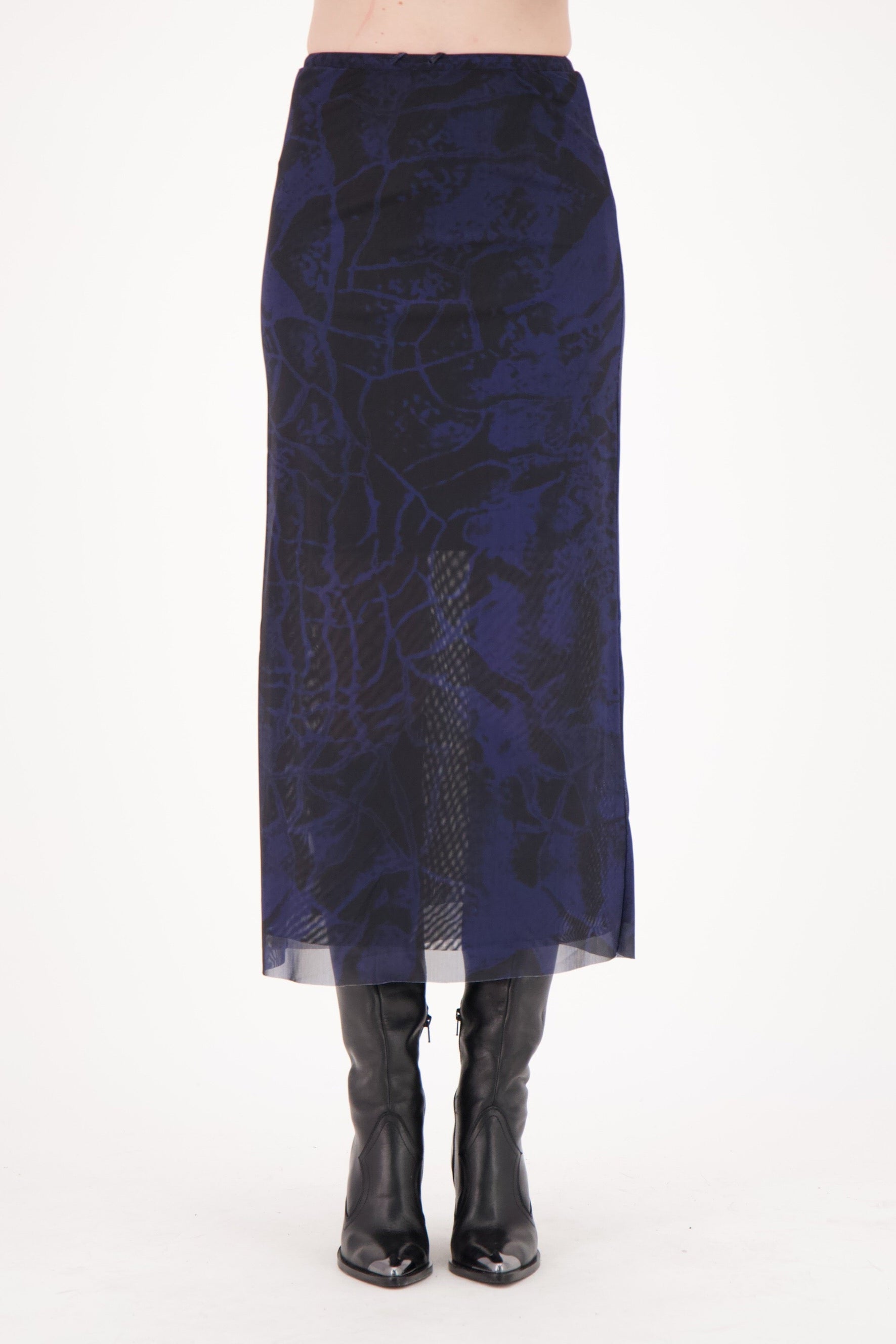 Navy patterned skirt worn by a person on a white background