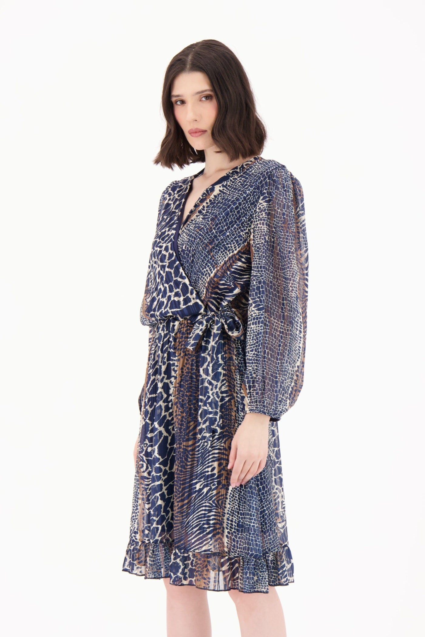 Woman wearing a patterned dress with a white background