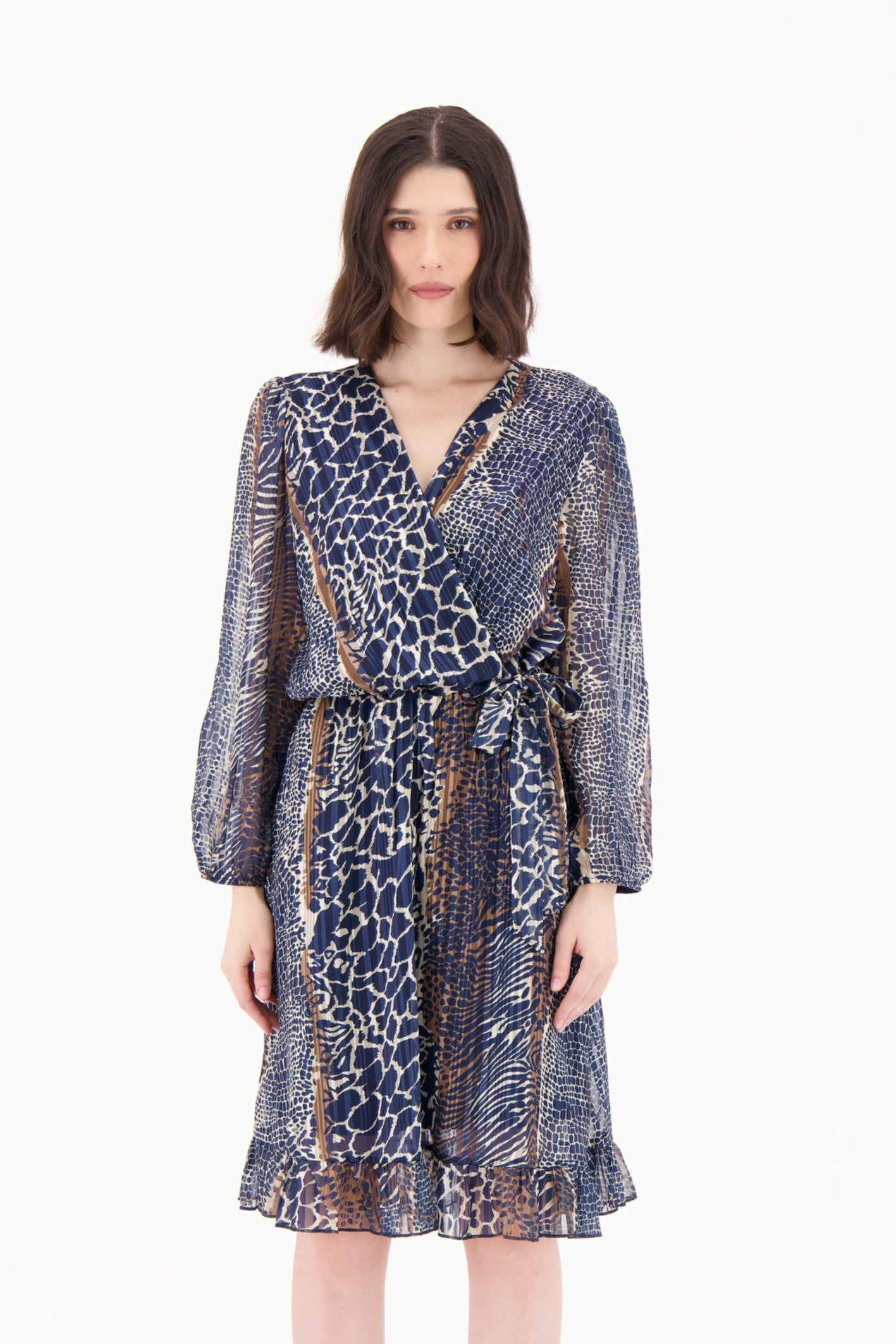 Woman wearing a patterned dress on a white background