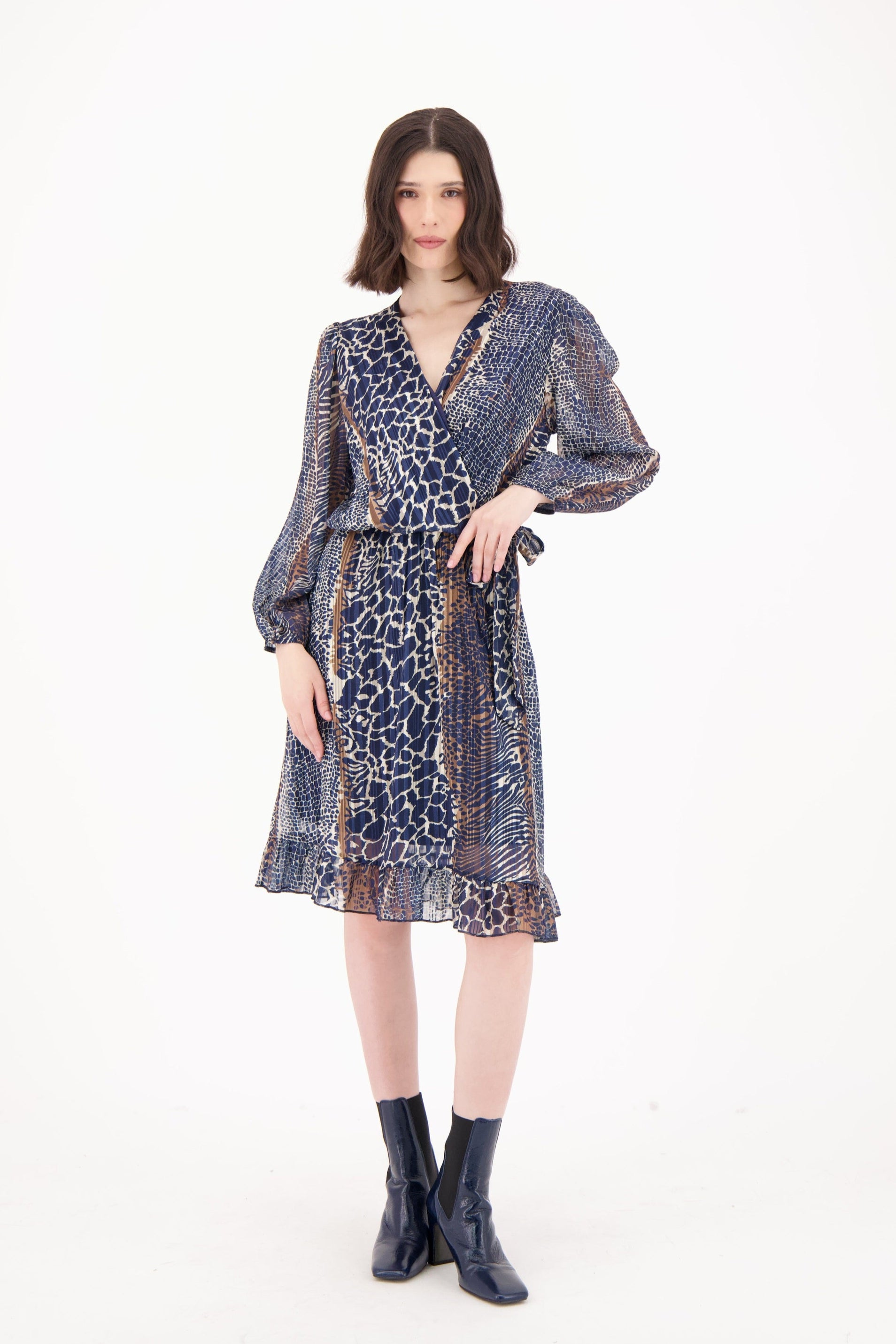 Woman wearing a patterned dress on a white background