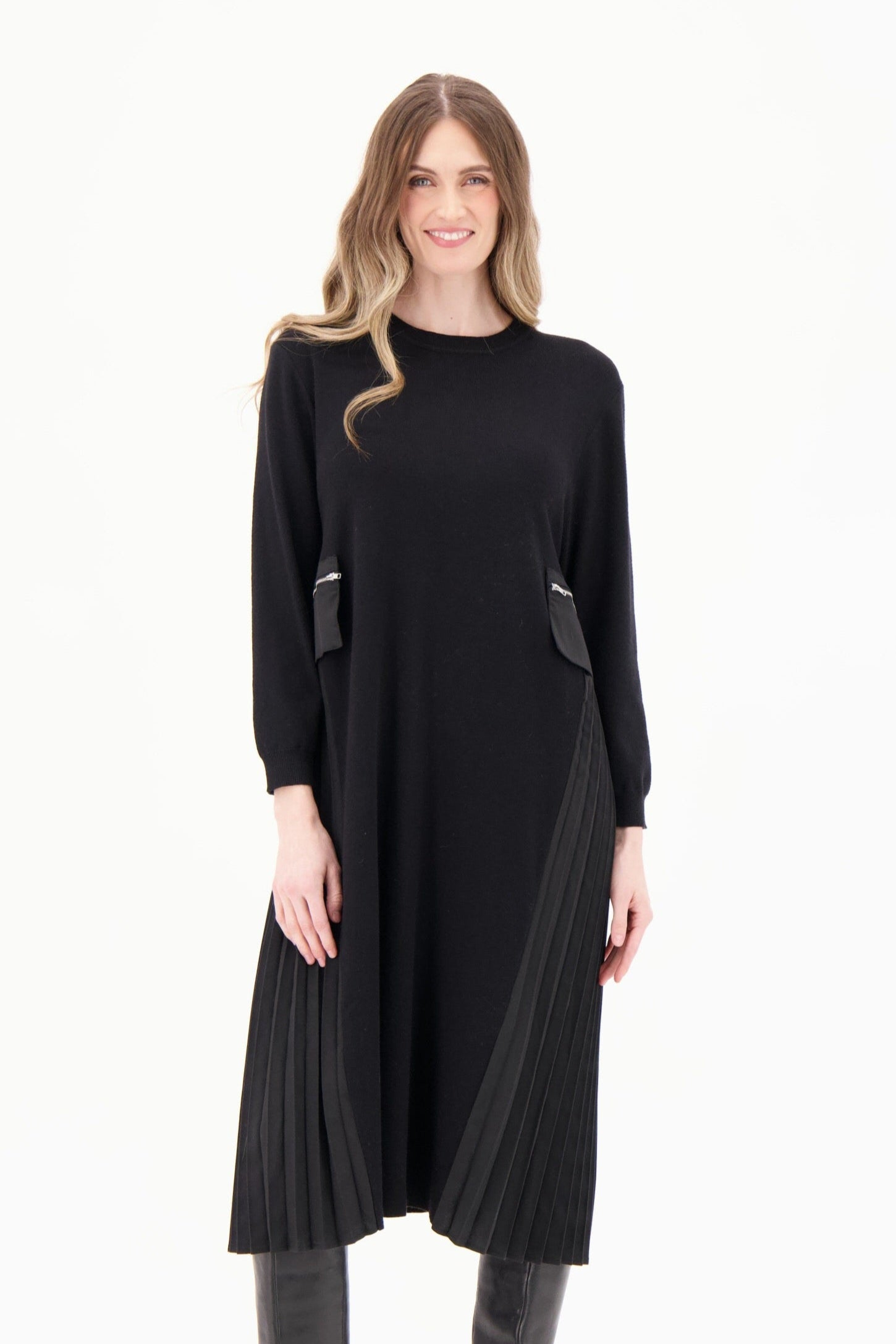 Woman wearing a black dress with gray boots on a white background