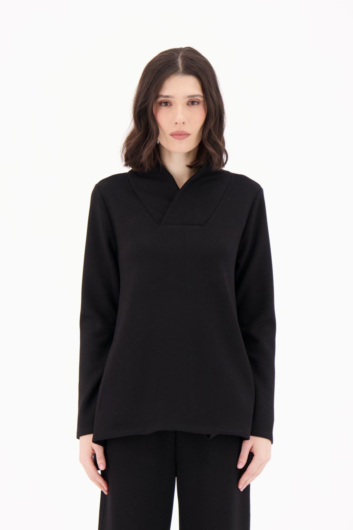 Woman wearing a black outfit on a white background