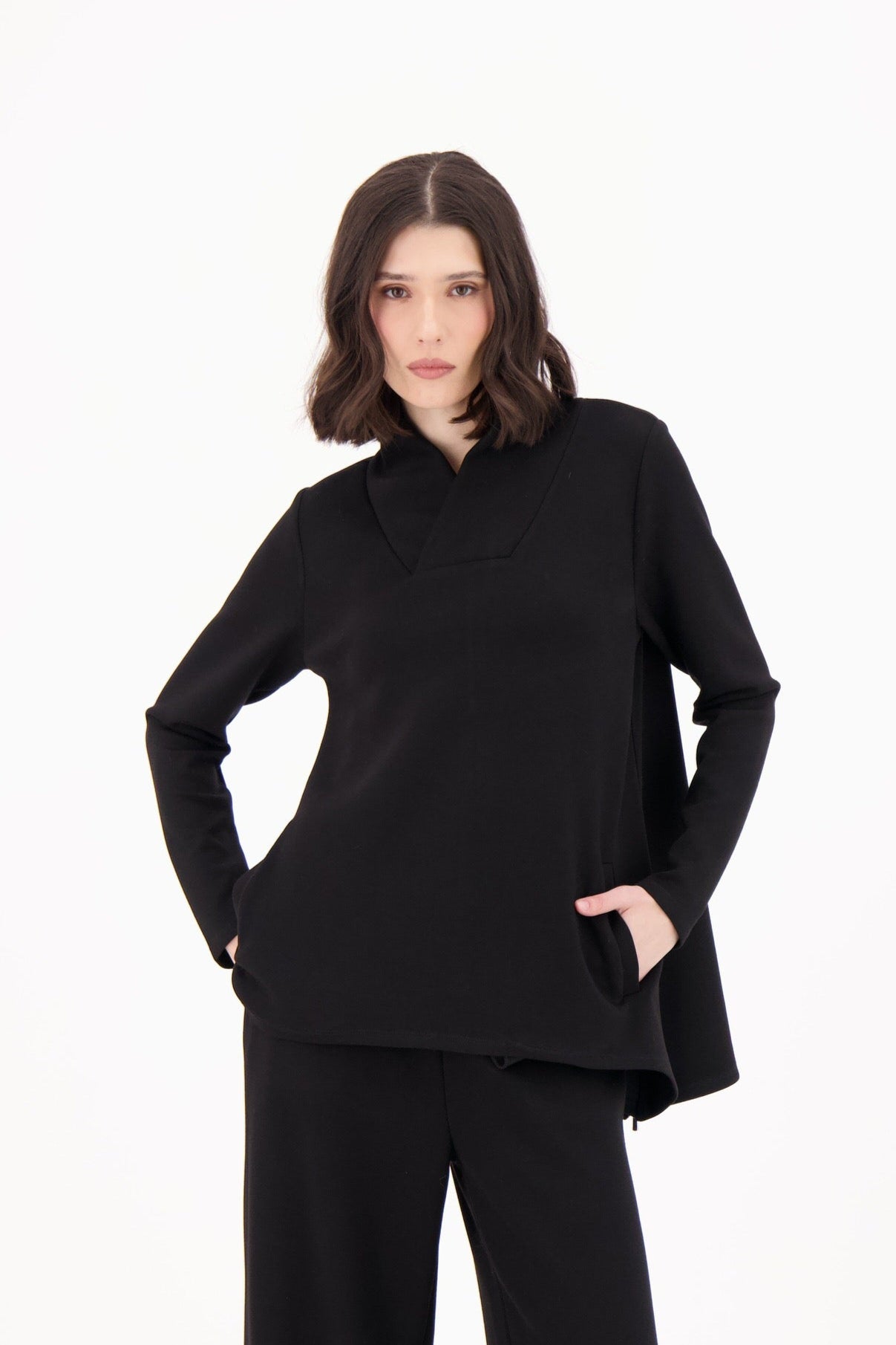 Woman wearing a black outfit on a white background